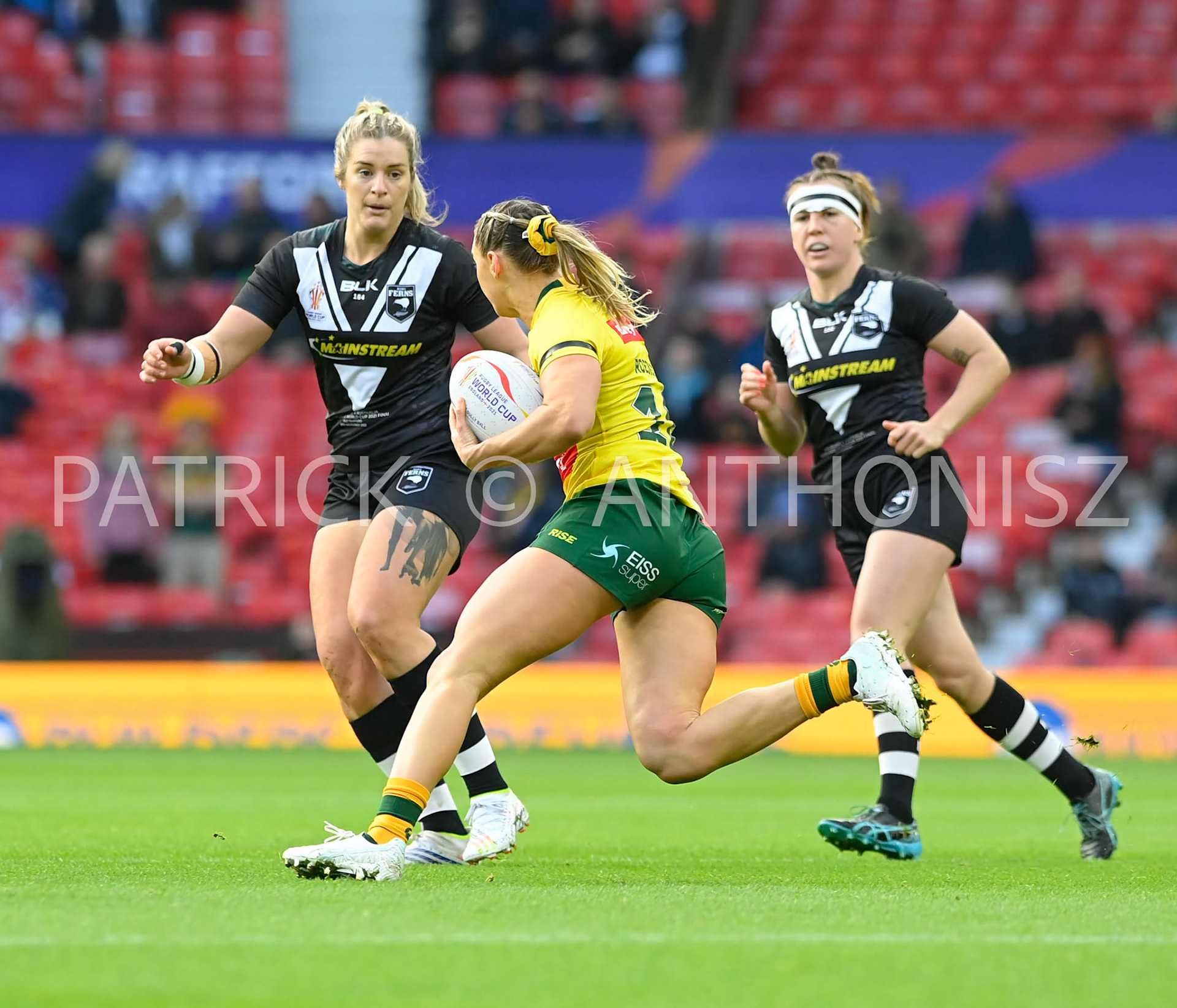 Manchester   ENGLAND - NOVEMBER 19. Julia Robinson of Australia tries to break away from the New Zealand defence players during  the Rugby league World Cup Womens Final  between Australia and New Zealand  at the Old Trafford   on November 19 - 2022 in Manchester England.
