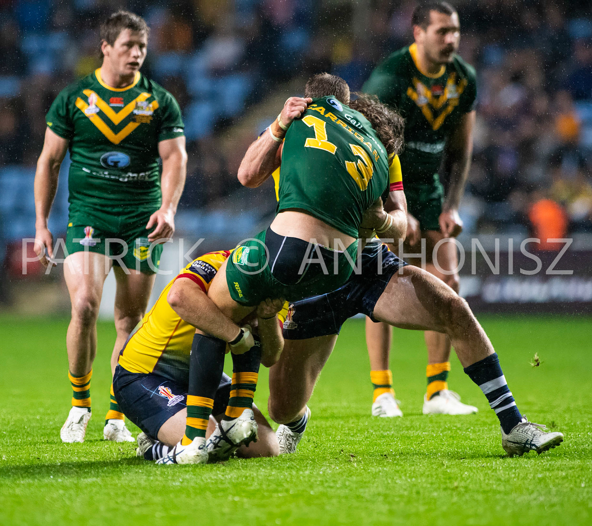 Coventry England  21st October: Patrick Carrigan of Australia is held by Jack Teanby and Logan Bayliss-Brow during the Rugby League World Cup 2021 between Australia Vs Scotland  at  Coventry Building Society Arena on 21st October 2022 Australia 84: Scotland 0