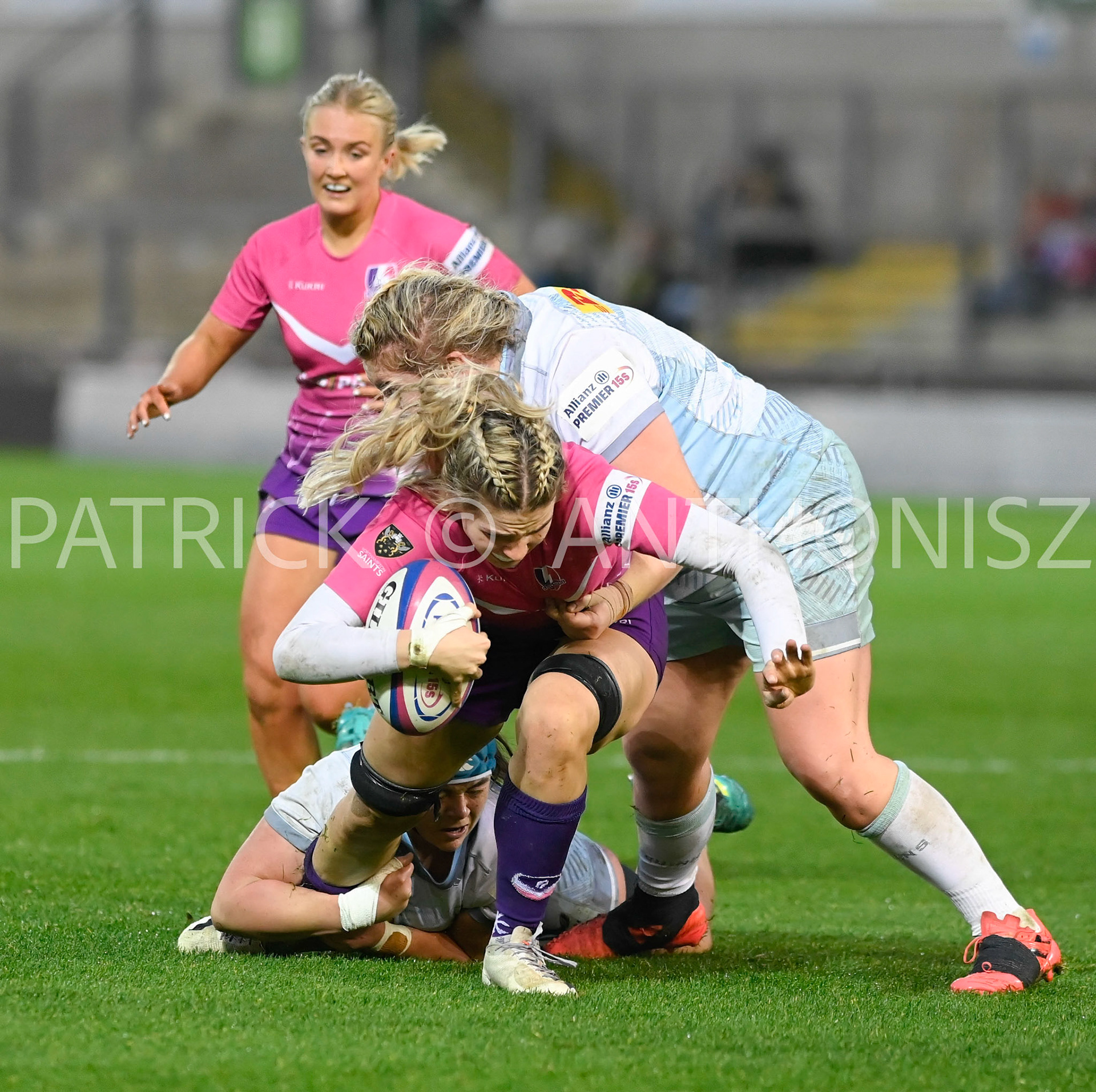 NORTHAMPTON, ENGLAND- Nov -27 - 2022 : Lilli Ives Campion of Loughborough Lightning is taken down by Harlequins Katy Mew and Hannah Duffy during the match between Loughborough Lightning Vs Harlequins at Franklin's Gardens on November 27, 2022 in Northampton, England