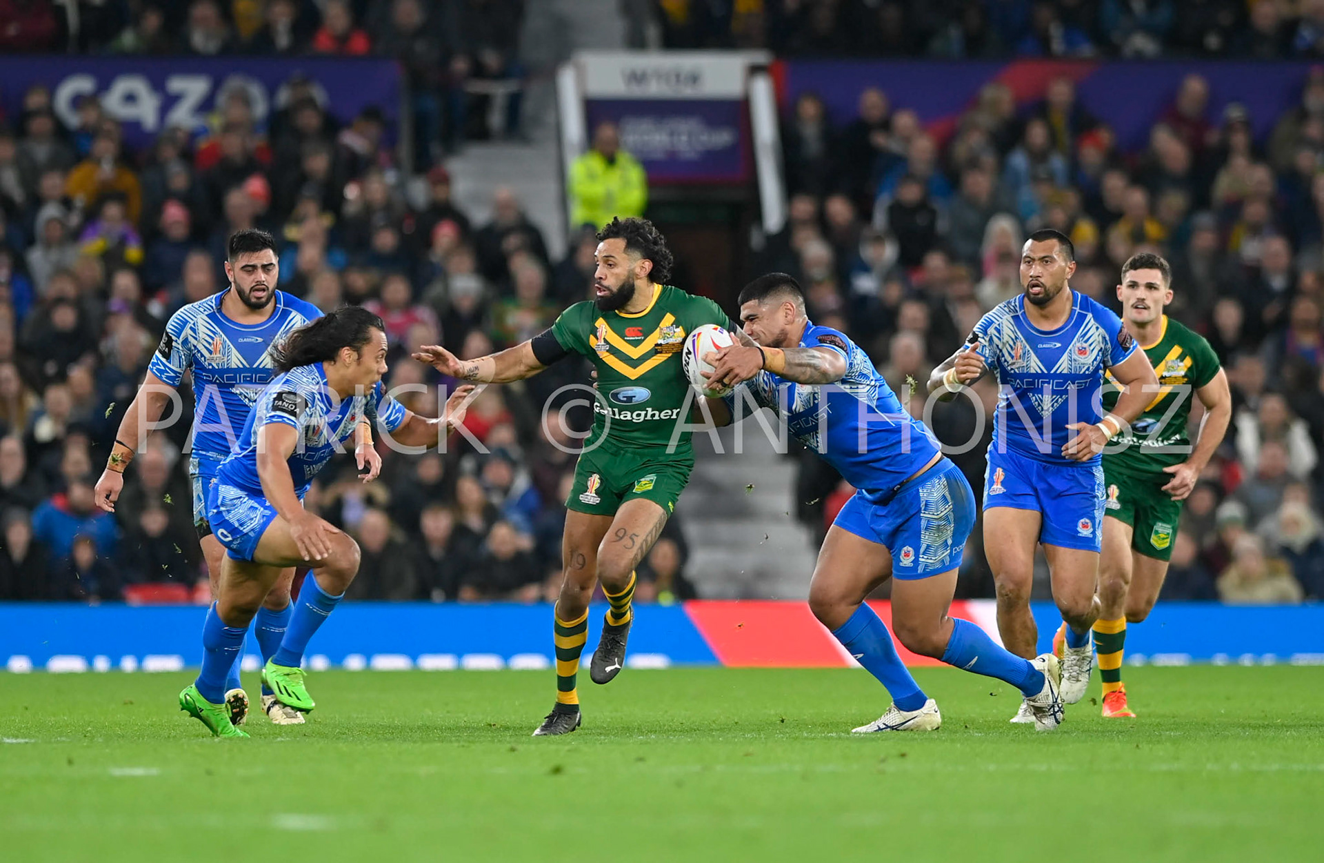 Manchester   ENGLAND - NOVEMBER 19.Josh Addo-Carr of Australia tries to break away from the Somoa defence during  the Rugby league World Cup Mens Final  between Australia and Samoa at the  Old Trafford Stadium on November 19 - 2022 in Manchester England.