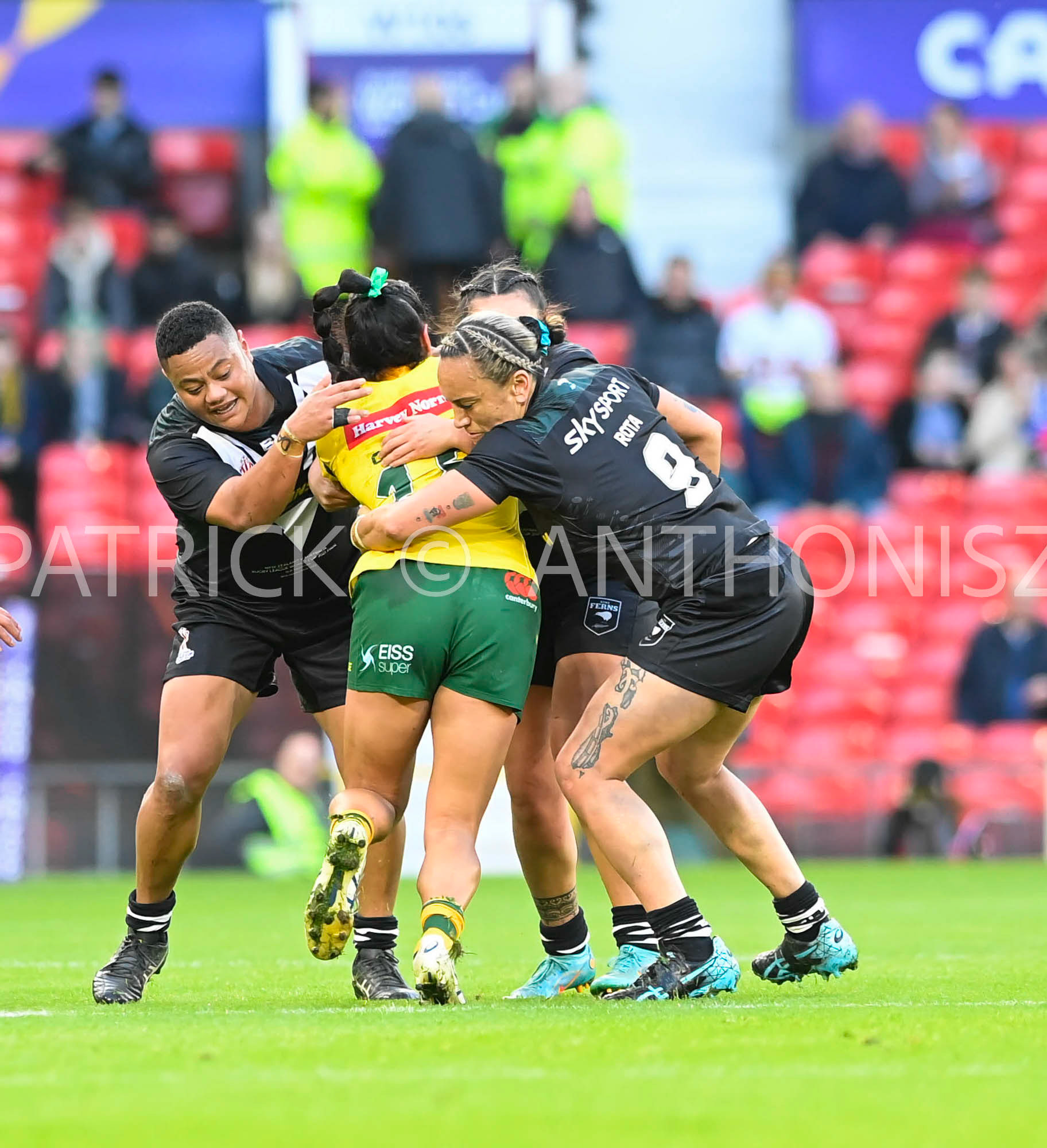 Manchester   ENGLAND - NOVEMBER 19.Yasmin Clydsdale of Australia tries to breakaway from the  New Zealand defence during  the Rugby league World Cup Womens Final  between Australia and New Zealand  at the Old Trafford   on November 19 - 2022 in Manchester England.