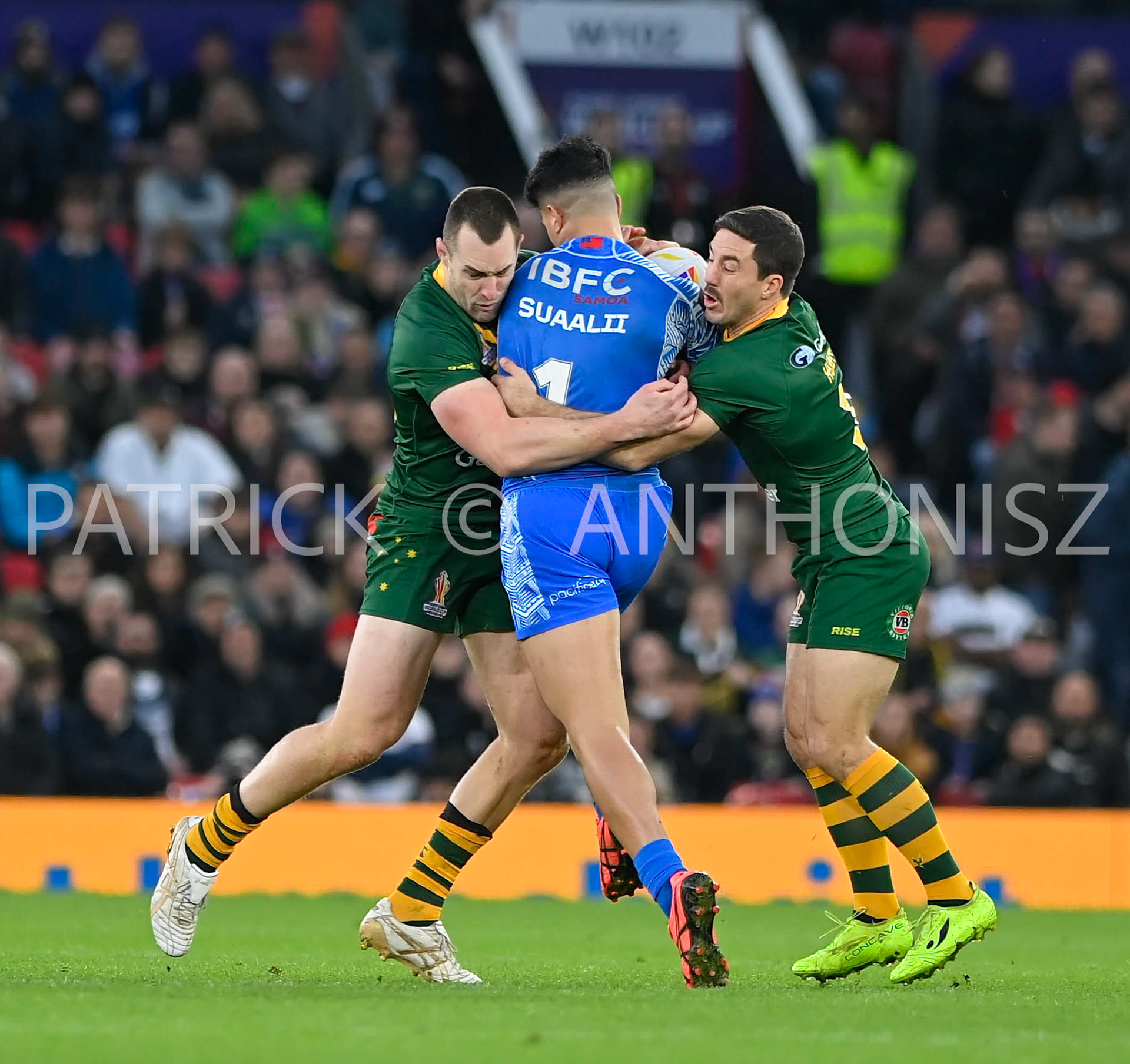Manchester   ENGLAND - NOVEMBER 19. Joseph Suaali'i of Samoa is stop by the Australian  defence teamm during  the Rugby league World Cup Mens Final  between Australia and Samoa at the  Old Trafford  Stadium on November 19 - 2022 in Manchester England.