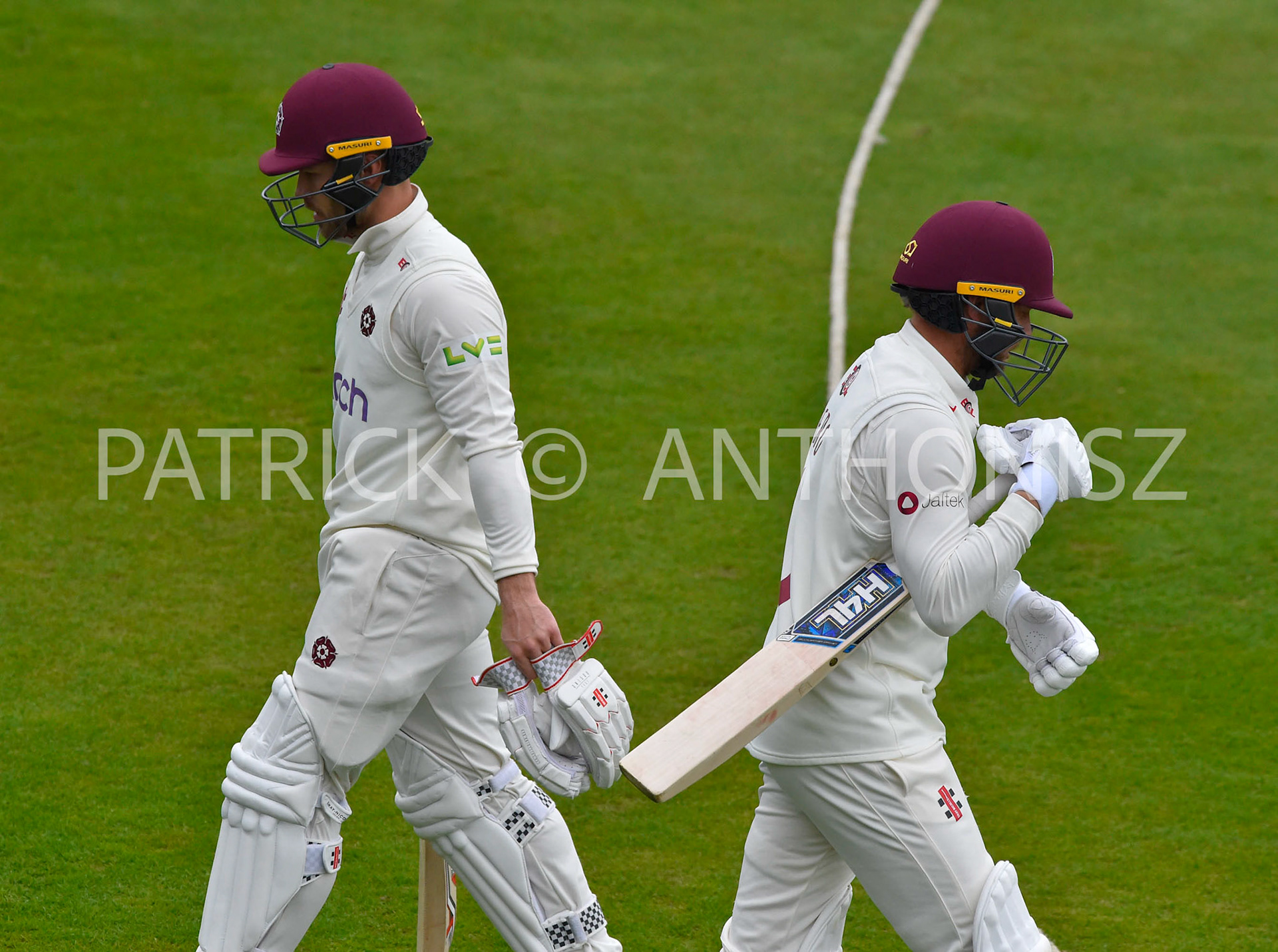 NORTHAMPTON, ENGLAND - April 15 2023 : Lewis Mcmanus of Northampton leaves the field while team mate Gareth Berg enters the field of play Day 3 of the LV= Insurance County Championship match between Northamptonshire and   Sat  April  15 at The County Ground  in Northampton, England.