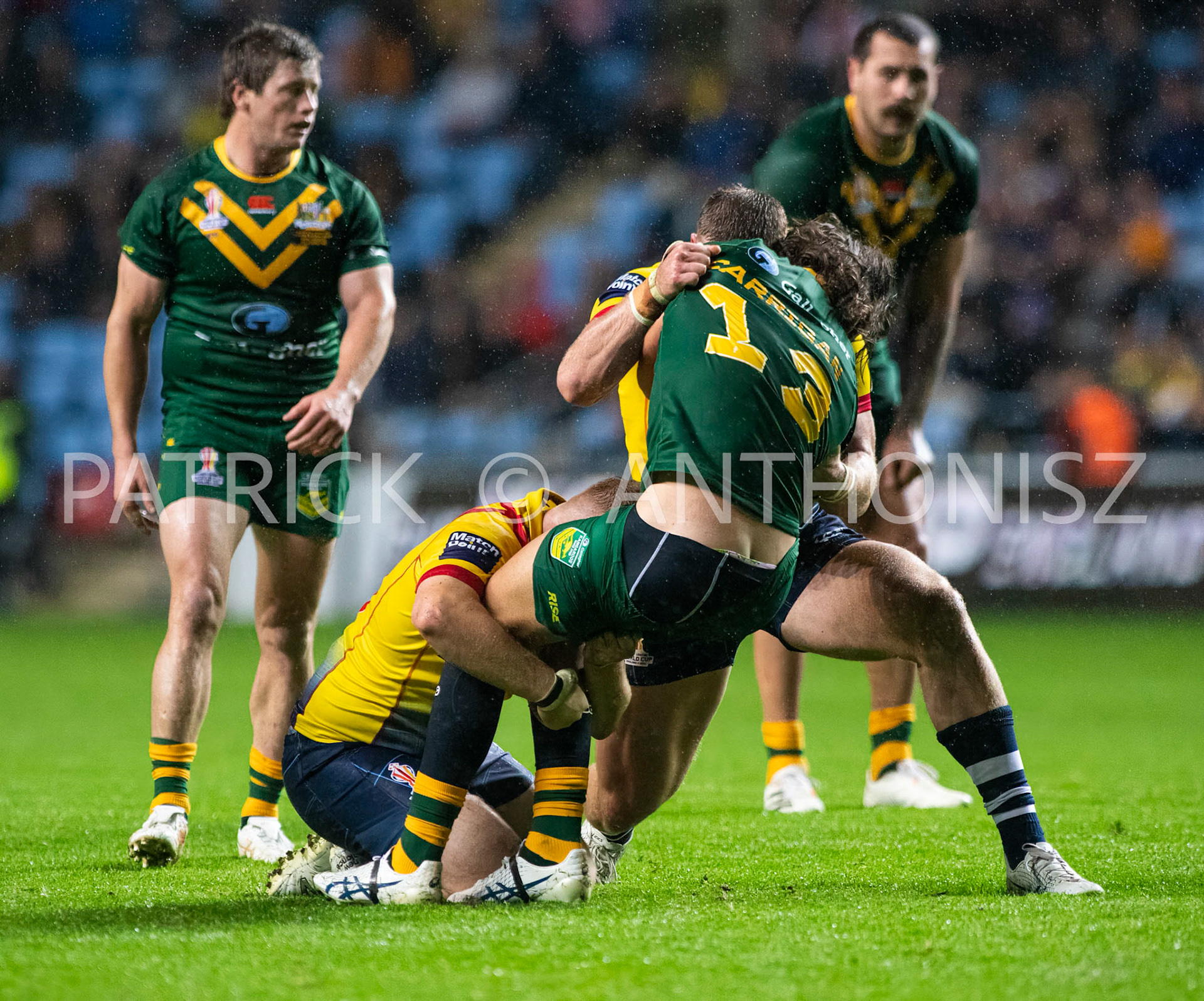 Coventry England  21st October: Patrick Carrigan of Australia is held by Jack Teanby and Logan Bayliss-Brow during the Rugby League World Cup 2021 between Australia Vs Scotland  at  Coventry Building Society Arena on 21st October 2022 Australia 84: Scotland 0