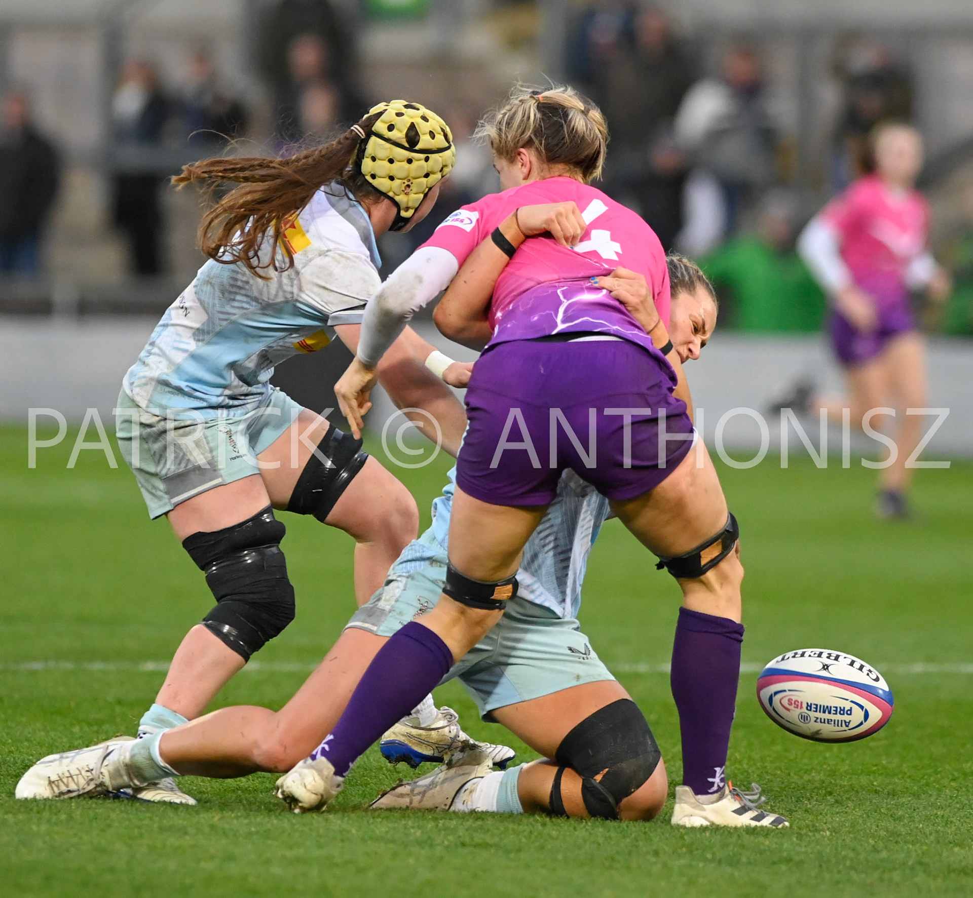 NORTHAMPTON, ENGLAND- Nov -27 - 2022 :  Lilli Ives Campion of Loughborough Lightning taken down by   Harlequins Emily Roboinson (vc) and Lagi Tuima during the match between Loughborough Lightning Vs Harlequins at Franklin's Gardens on November 27, 2022 in Northampton, England