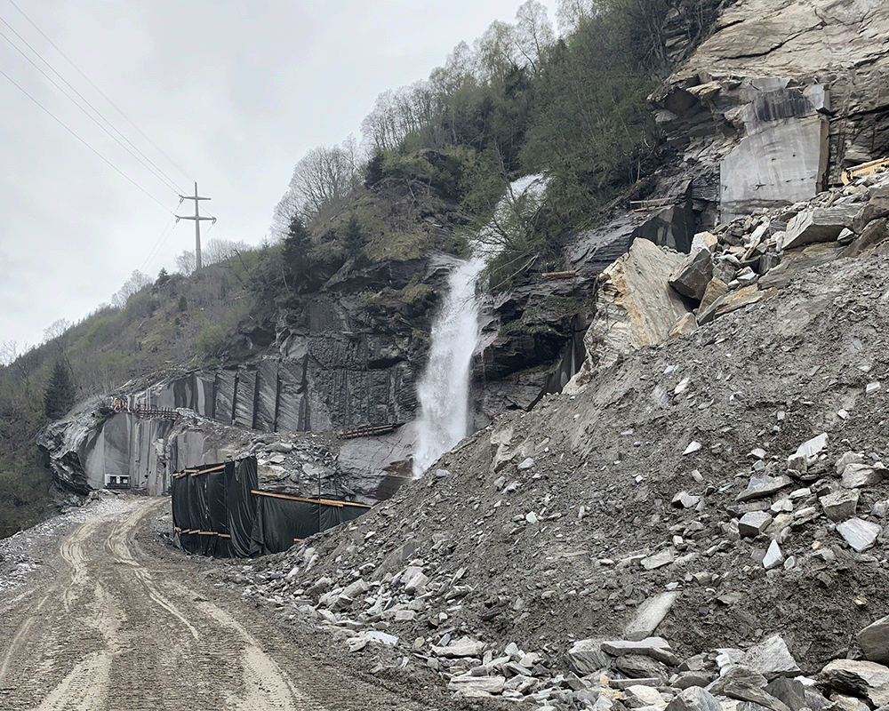 Natural waterfall at Turffer AG Quarry in the side of a mountain