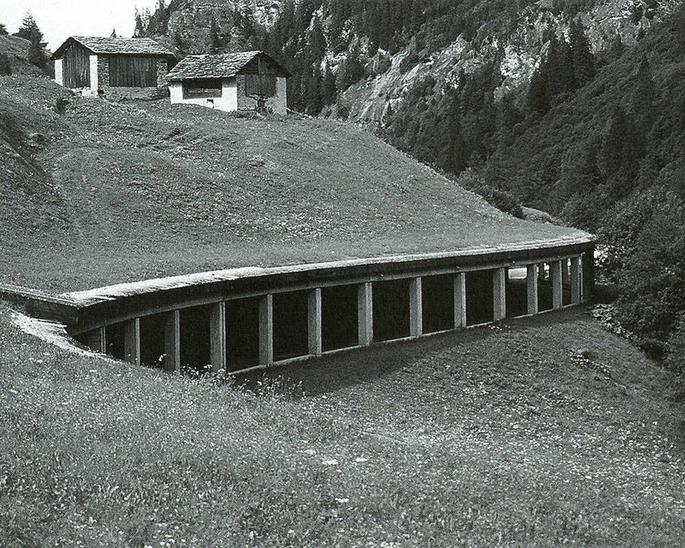 Cliff-side tunnels between Ilanz and Vals, Switerland with traditional vernacular farm huts above