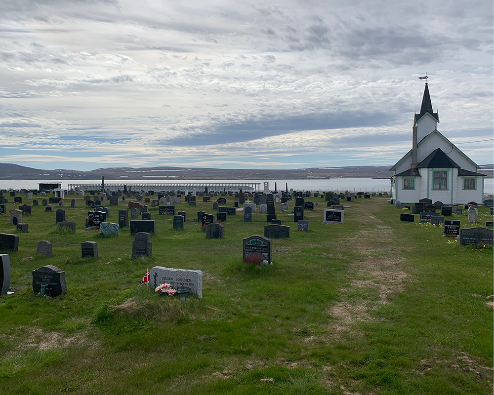 Vardø cemetery with chapel and Steilineset Minnested by Peter Zumthor in the background in Norway