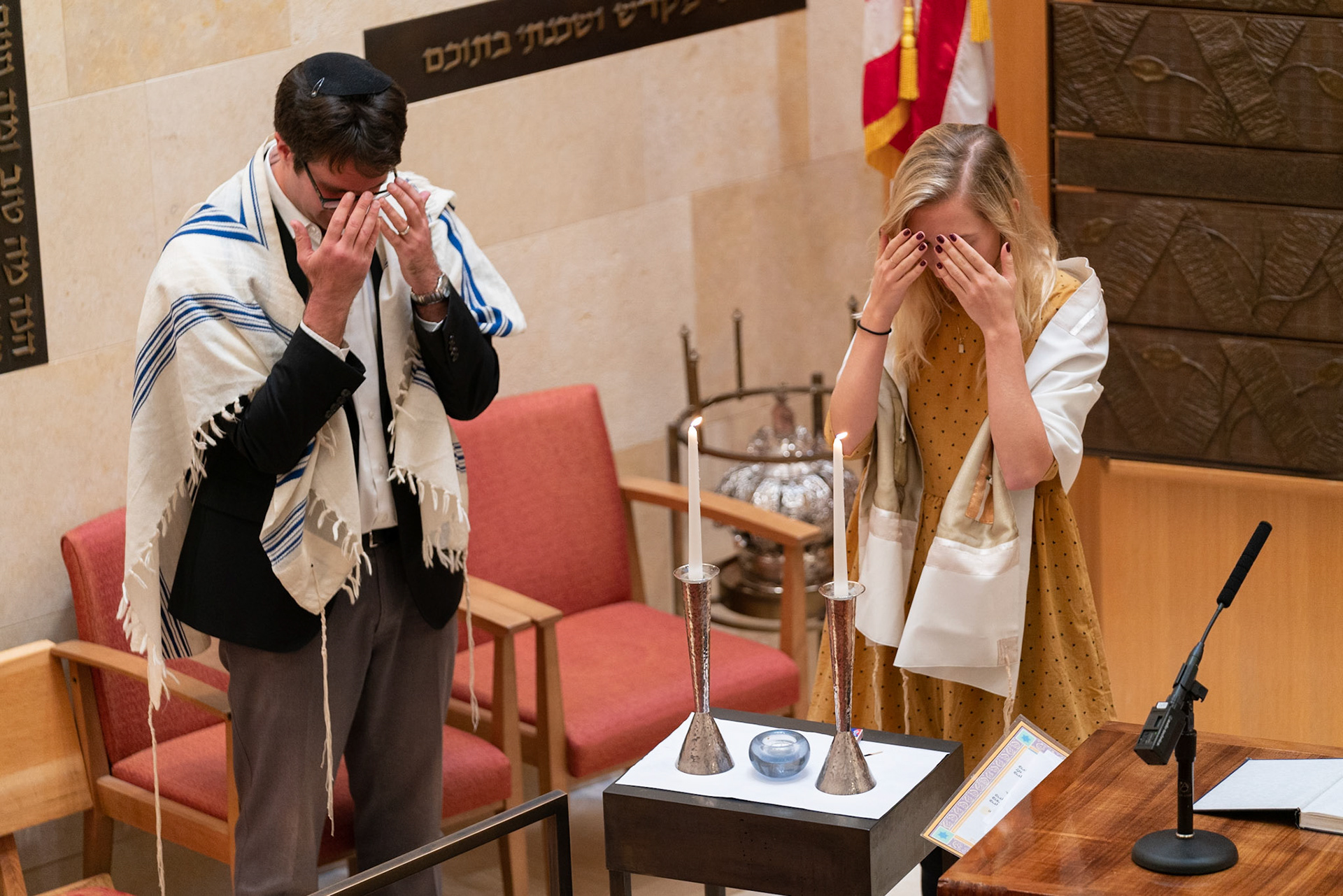 Joshua Stanton, a Gramercy neighborhood Rabbi, lights the Shabbos candles alongside student cantor.