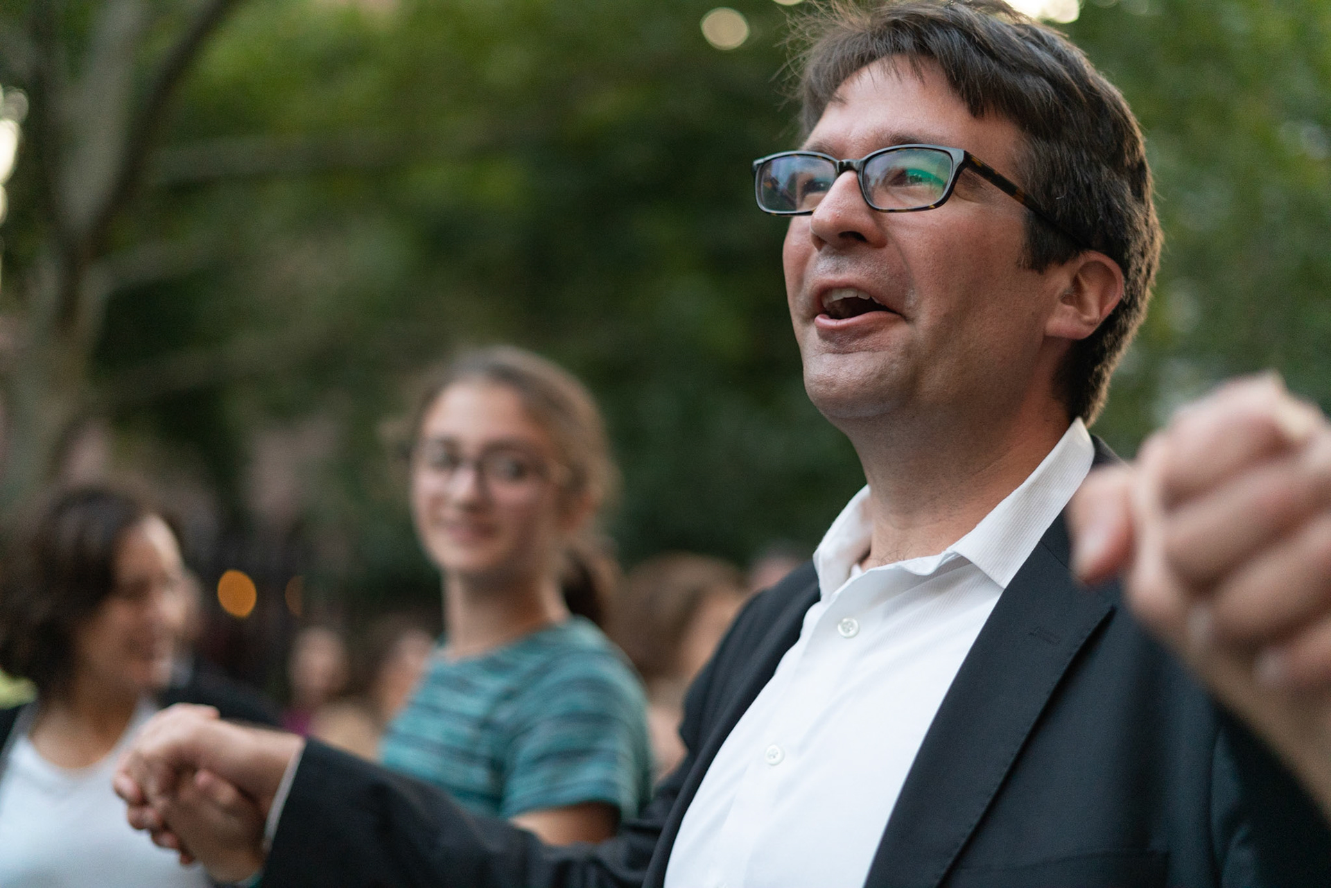 Josh dances in the street with his congregation in front of the temple on Simchat Torah.