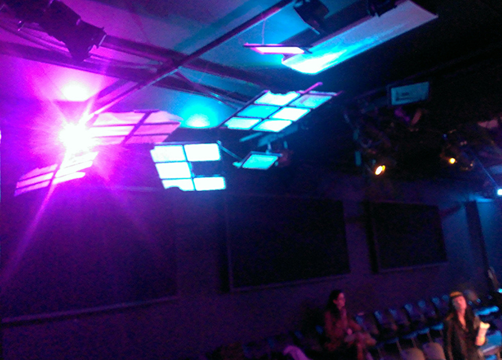 Broken windows hung from grid above