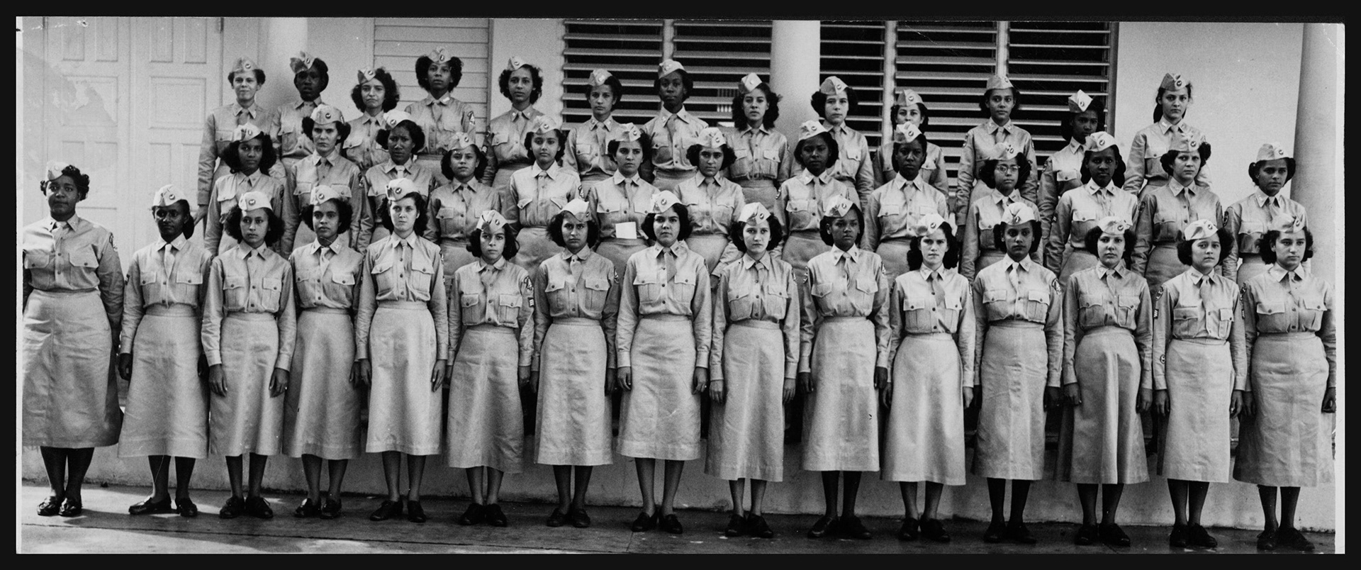 Grupo de mujeres cadetes paradas en atención durante ceremonia de premiación a miembros de la Patrulla Aérea Civil de la Escuela Superior Central de Santurce..Octubre 22, 1951