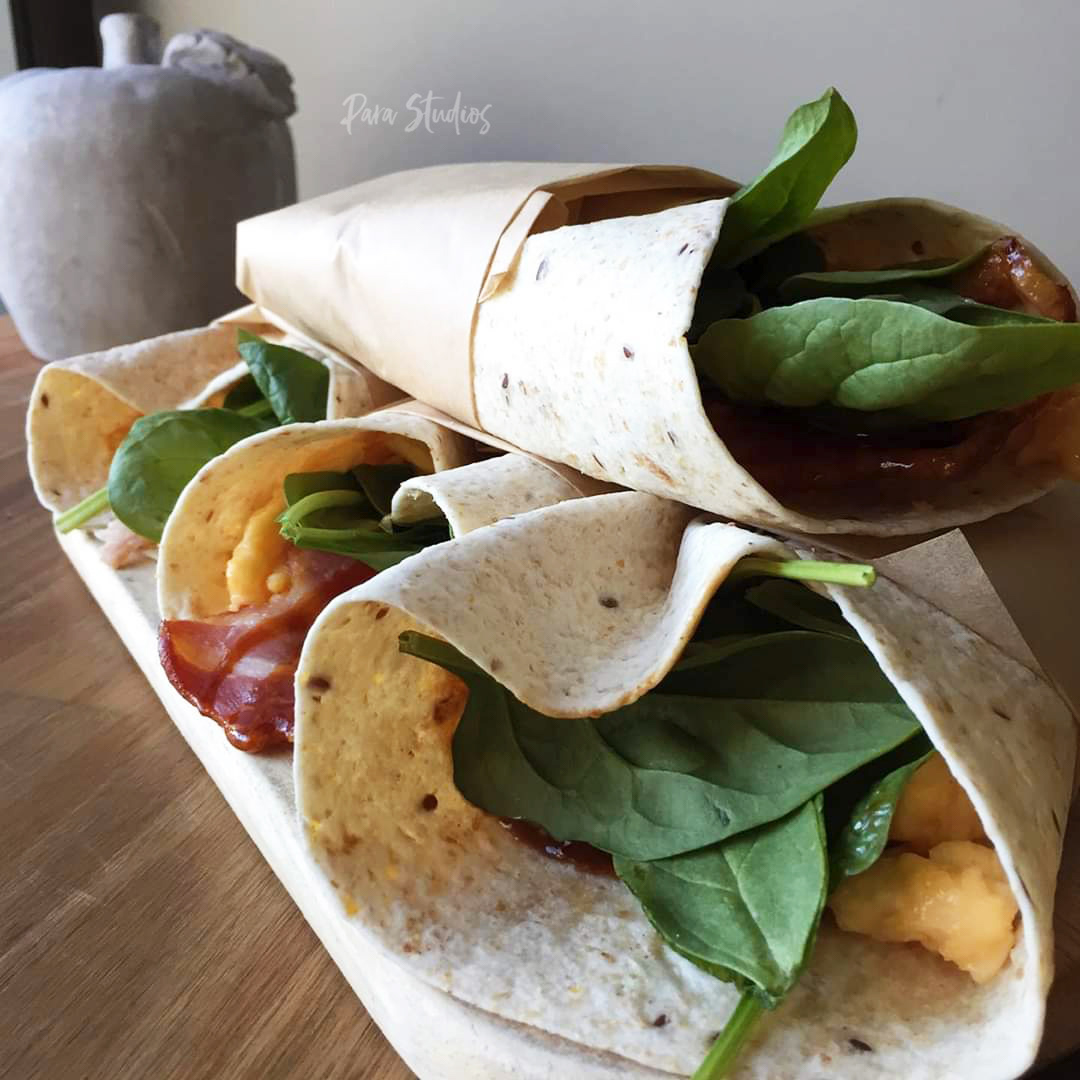 Scrambled eggs, spinach and bacon brekky wrap