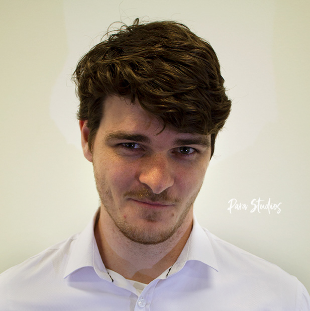 A portrait of Billy, they wear a white shirt.