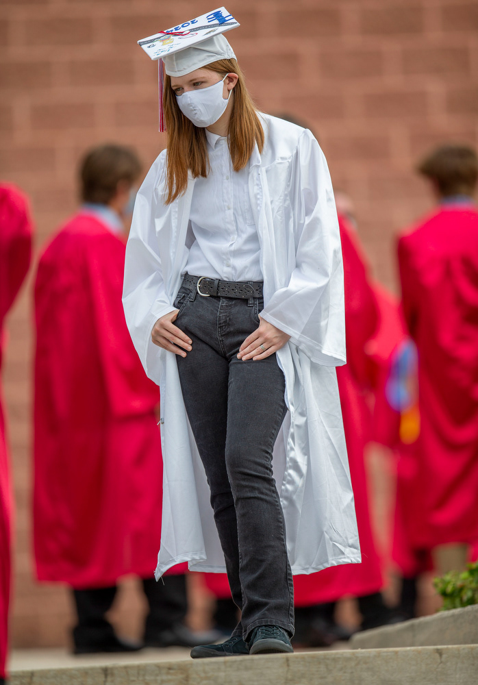 Laura Lakey, one of over 450 Cumberland Valley High School seniors, waits for the start of COVID-19 delayed commencement ceremonies for the class of 2020, in Mechanicsburg, Pa., Aug. 1, 2020.