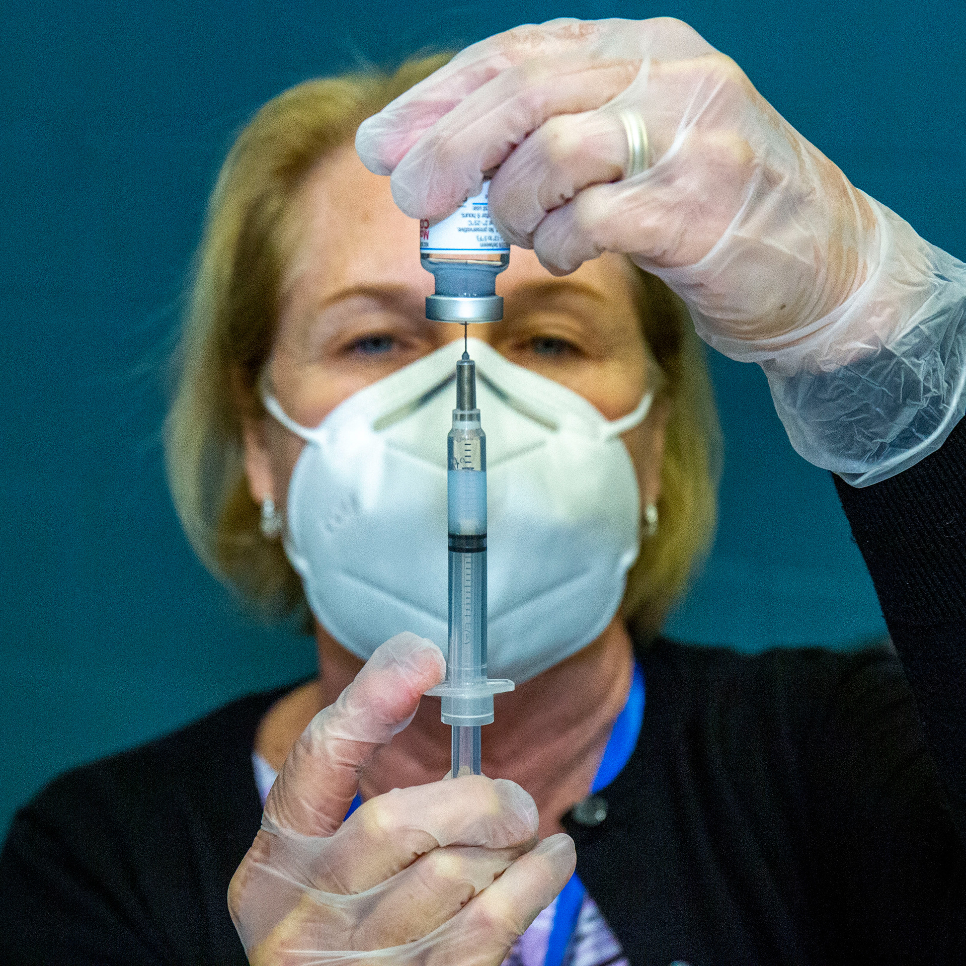 Gail Henschke, Hershey, draws a .5ml shot of the Moderna vaccine to fight COVID-19 as people line up for shots at a LeSean McCoy Foundation hosted vaccination clinic at the Camp Curtin YMCA in Harrisburg, Pa., Apr. 3, 2021.