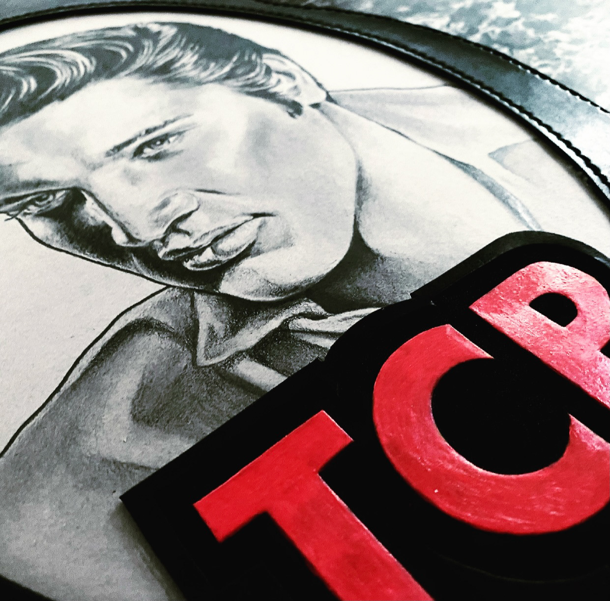 Graphite on board with carved leather frame on wood plaque 