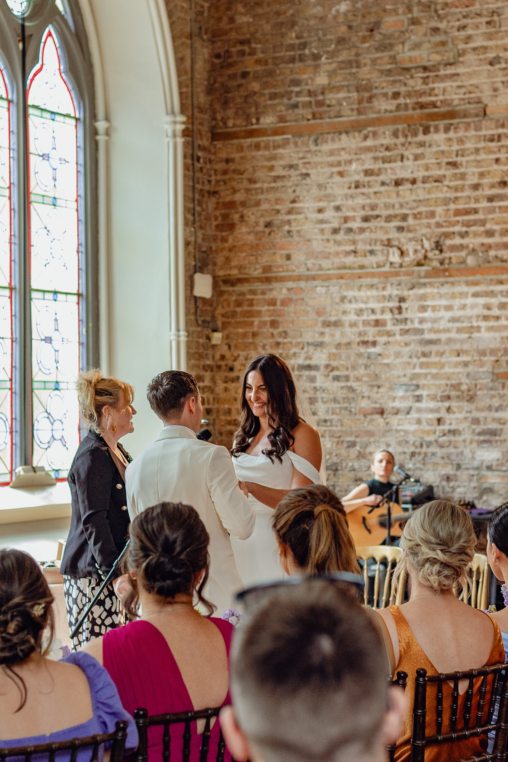wedding couple look at each at the altar