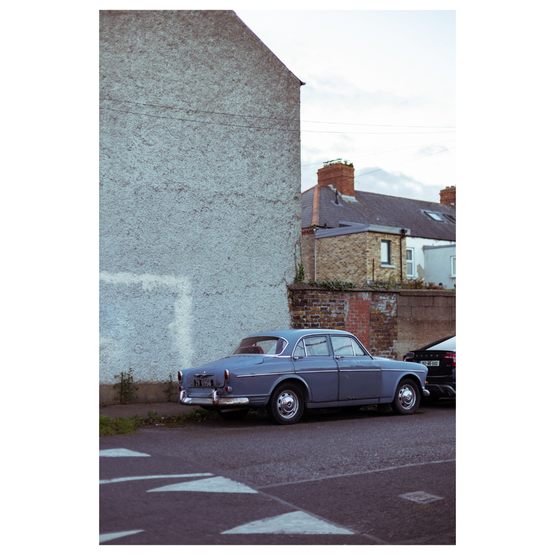 blue old fashioned car on street
