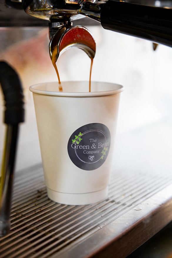 close up of coffee holder pouring coffee into coffee cup