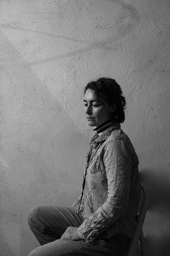 B&W portrait of woman sitting and looking down