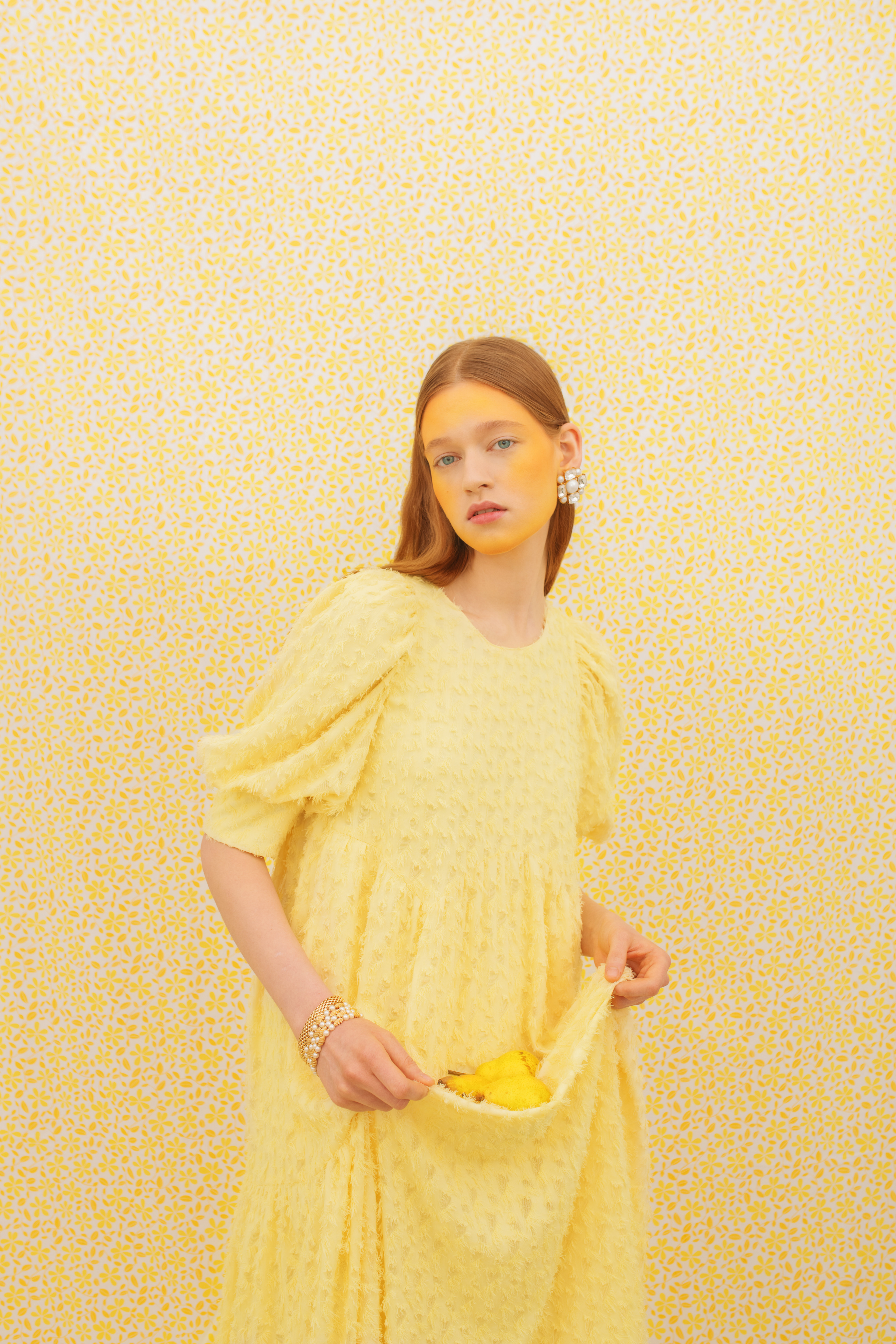 yellow editorial shot of a woman in the centre