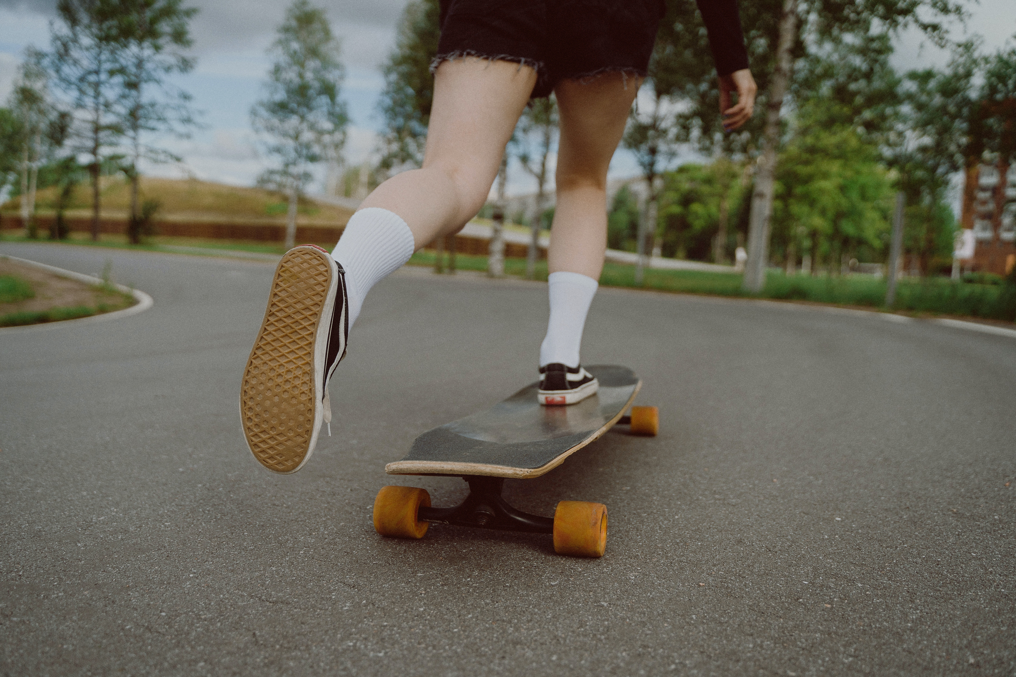 Photo by cottonbro studio: https://www.pexels.com/photo/woman-in-white-socks-and-black-shoes-riding-on-black-skateboard-5026427/