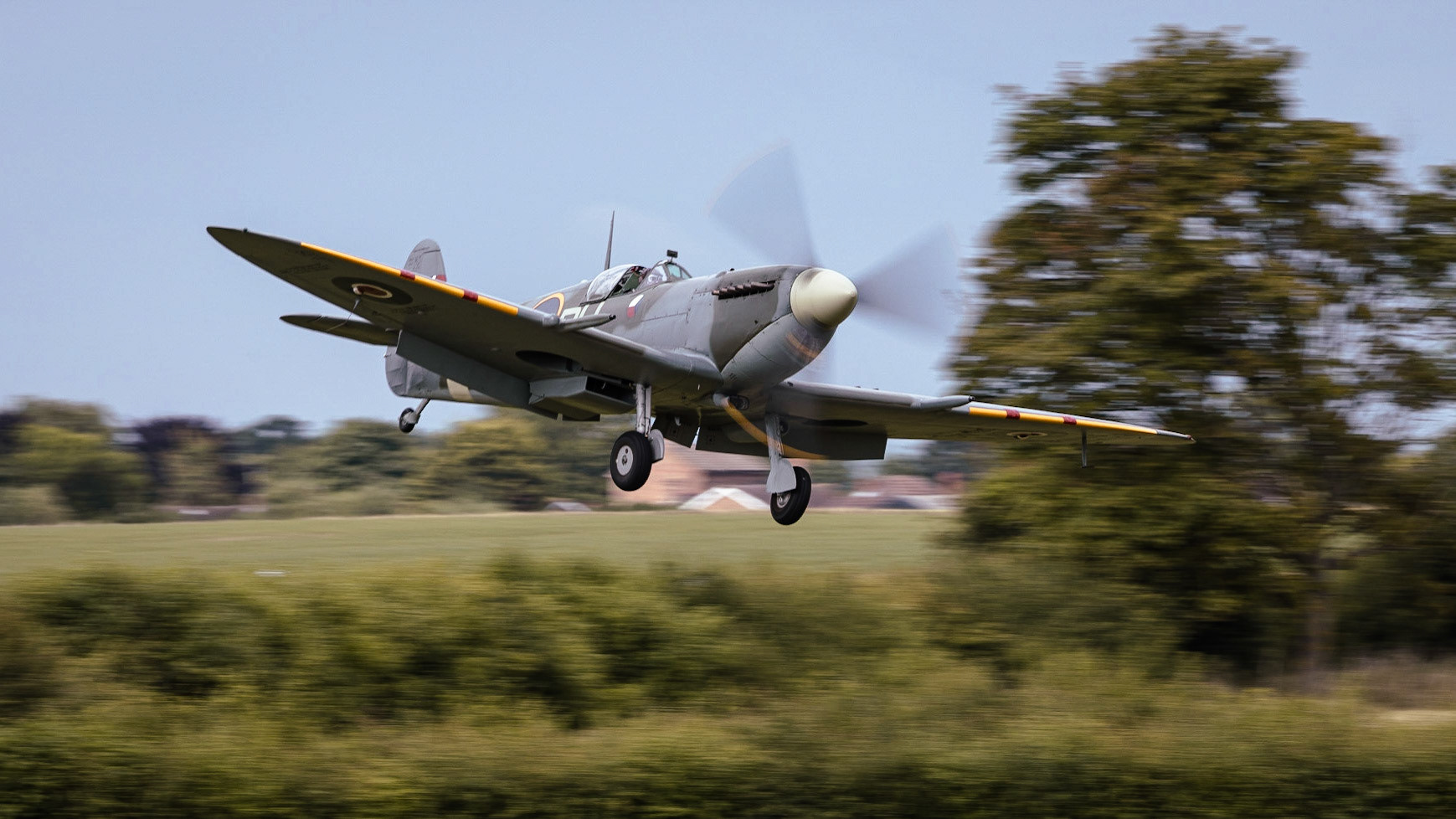 A vintage WW2 Spitfire fighter aircraft in flight