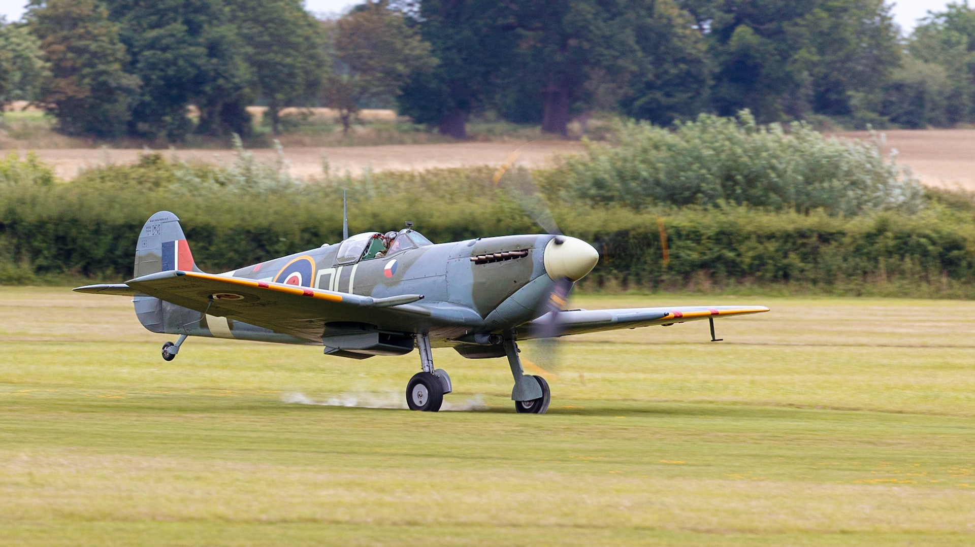 Old Warden, UK - 4th August 2019: A vintage world war two British Spitfire fighter plane landing on airfileld