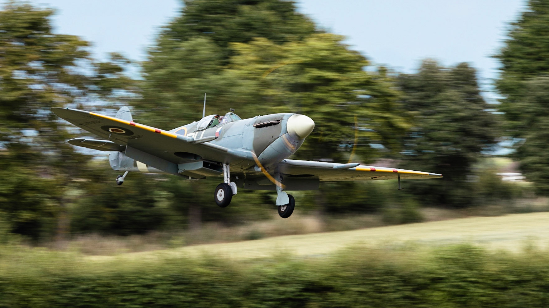 A vintage WW2 Spitfire fighter aircraft in flight