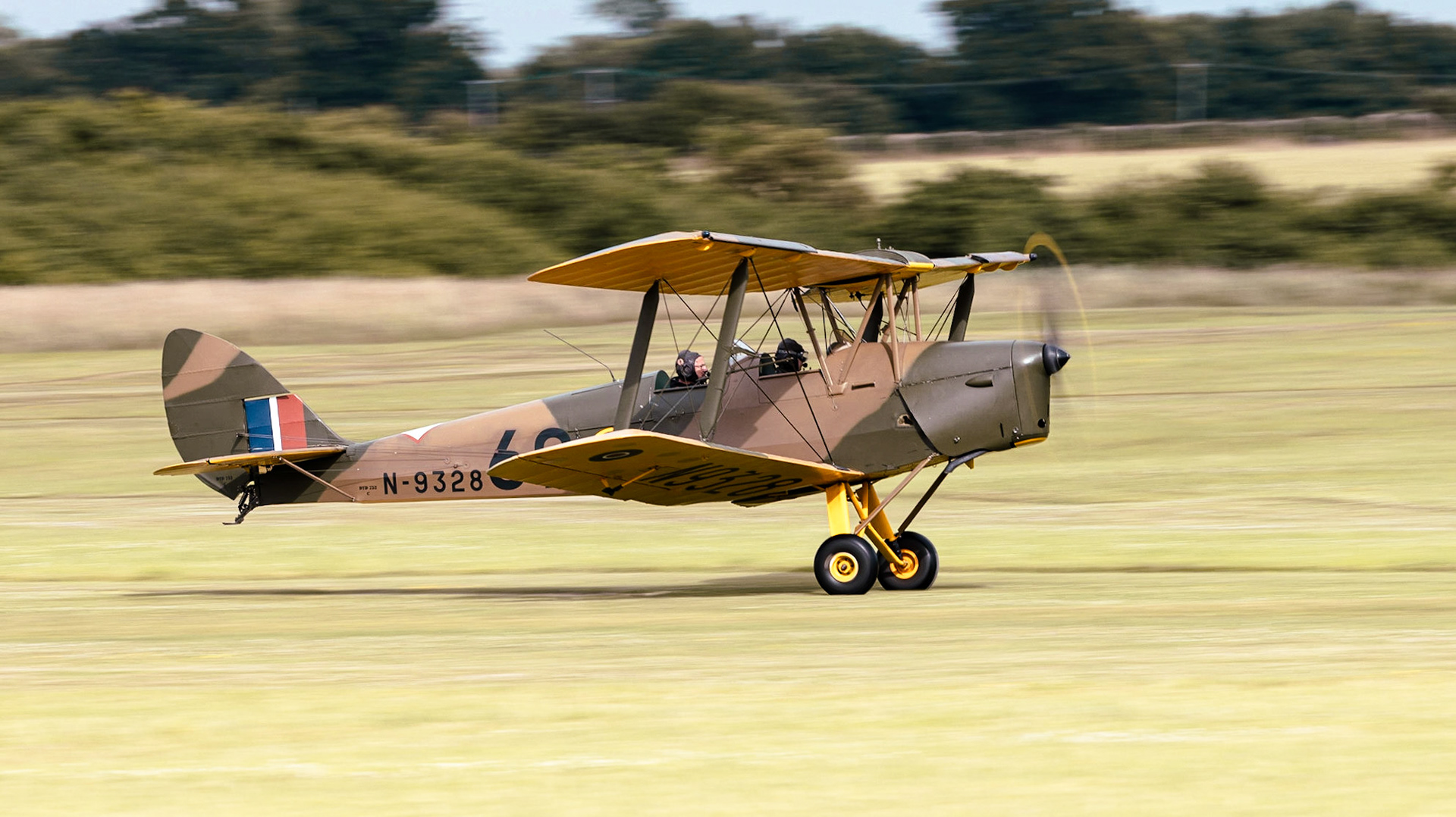 Old Warden, UK - 3rd July 2022: A vintage de Havilland Tiger Moth DH 82A trainer aircraft landing on grass