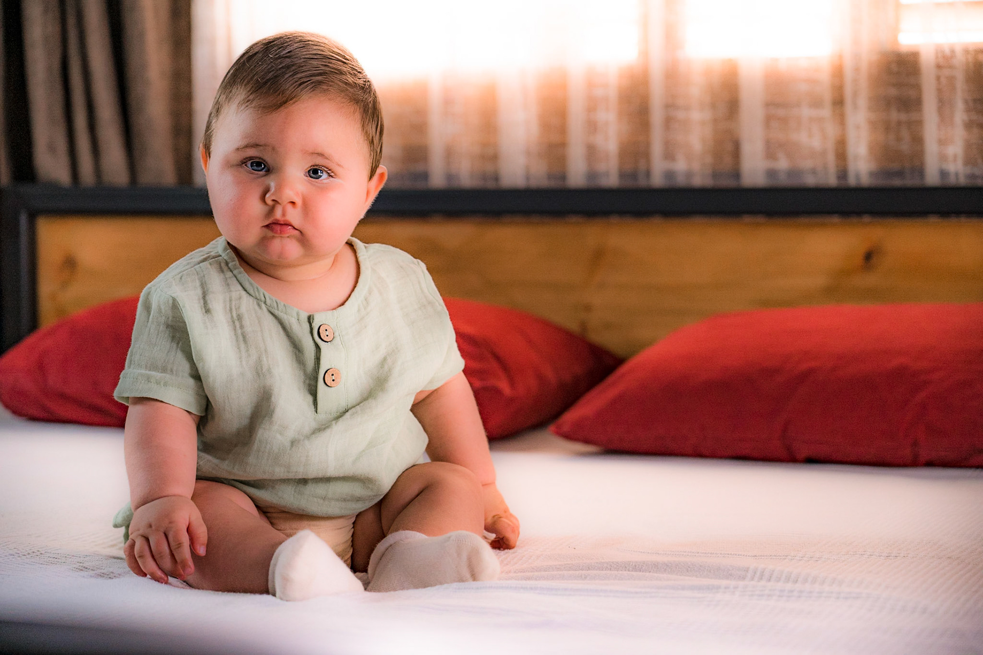 Sitting baby in vintage clothes for photo shoot