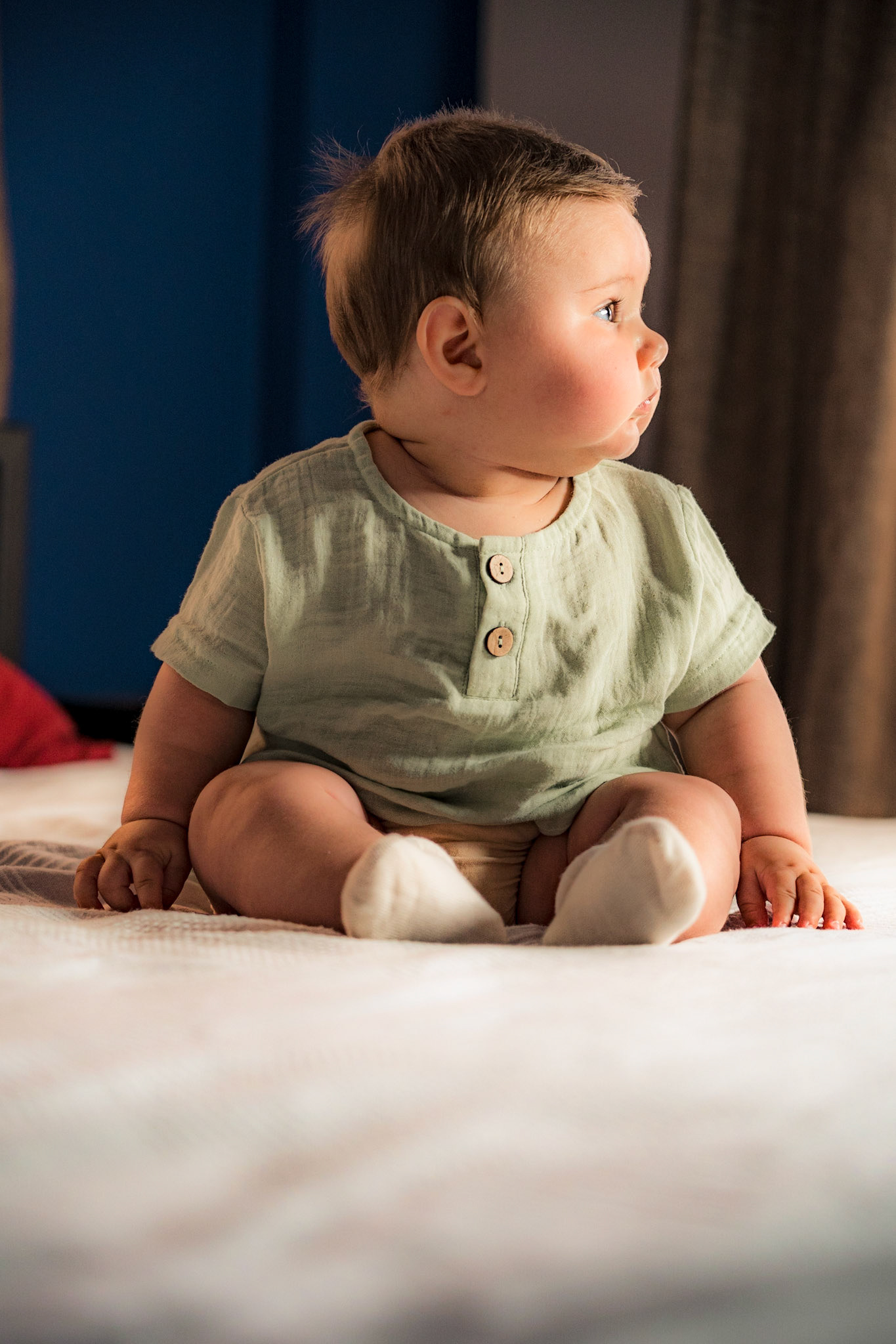 Sitting baby in vintage clothes for photo shoot
