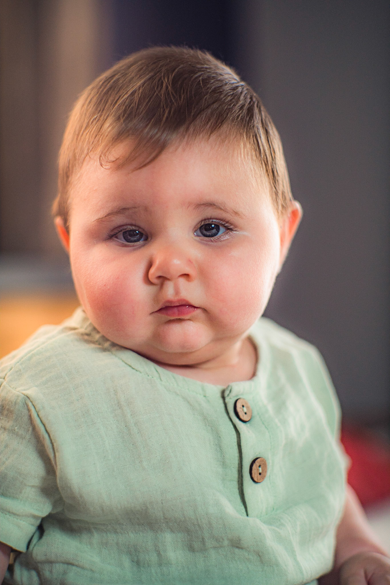 Sitting baby in vintage clothes for photo shoot