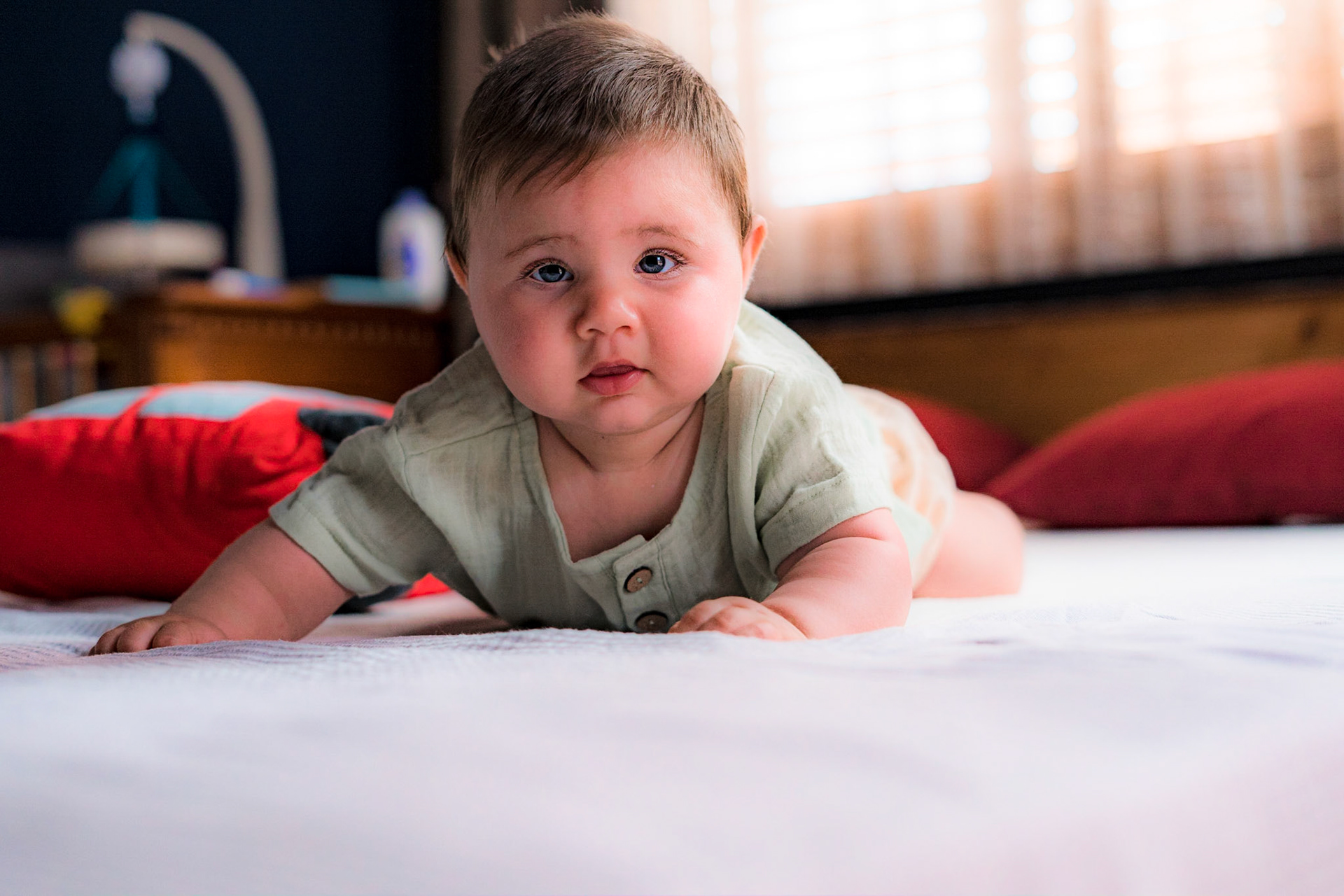 Sitting baby in vintage clothes for photo shoot