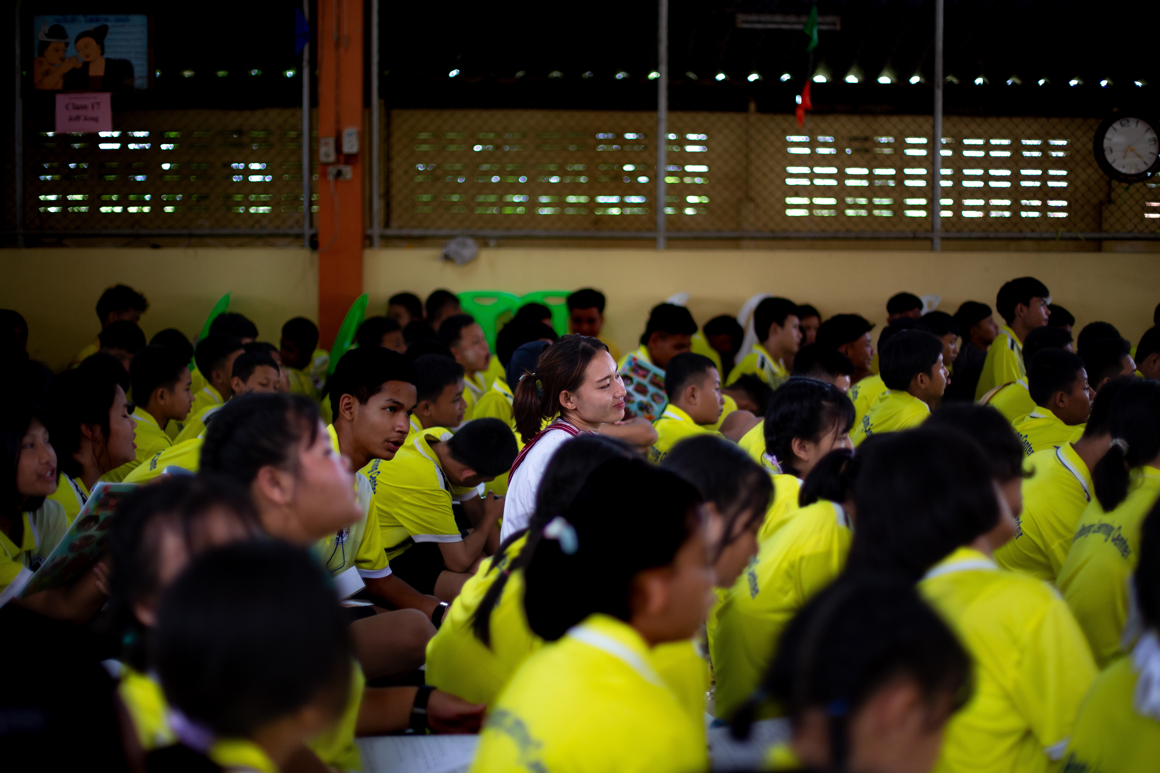 Nan Hser Tha Mote, 28, joins her students during orientation at a summer camp organised by migrant schools in Mae Sot. Held annually with support from the Peach Foundation, these camps welcome volunteers from the U.S. to connect with students and teachers. The program covers a range of topics, from English language learning to mental health awareness. July 2024
