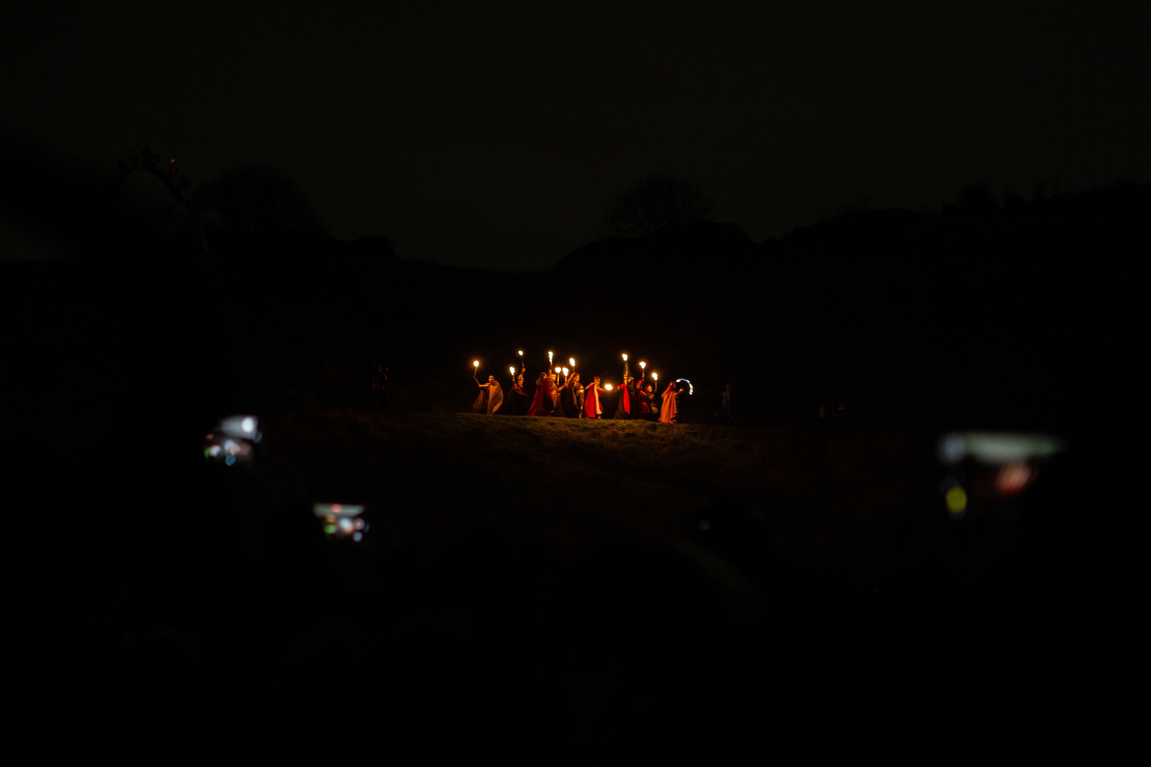 The festival begins with performers leading a procession from the top of Arthur’s seat at the Samhuinn festival in Edinburgh on October 31. Attendees of the festival try and take videos and photos with their phones of the procession.