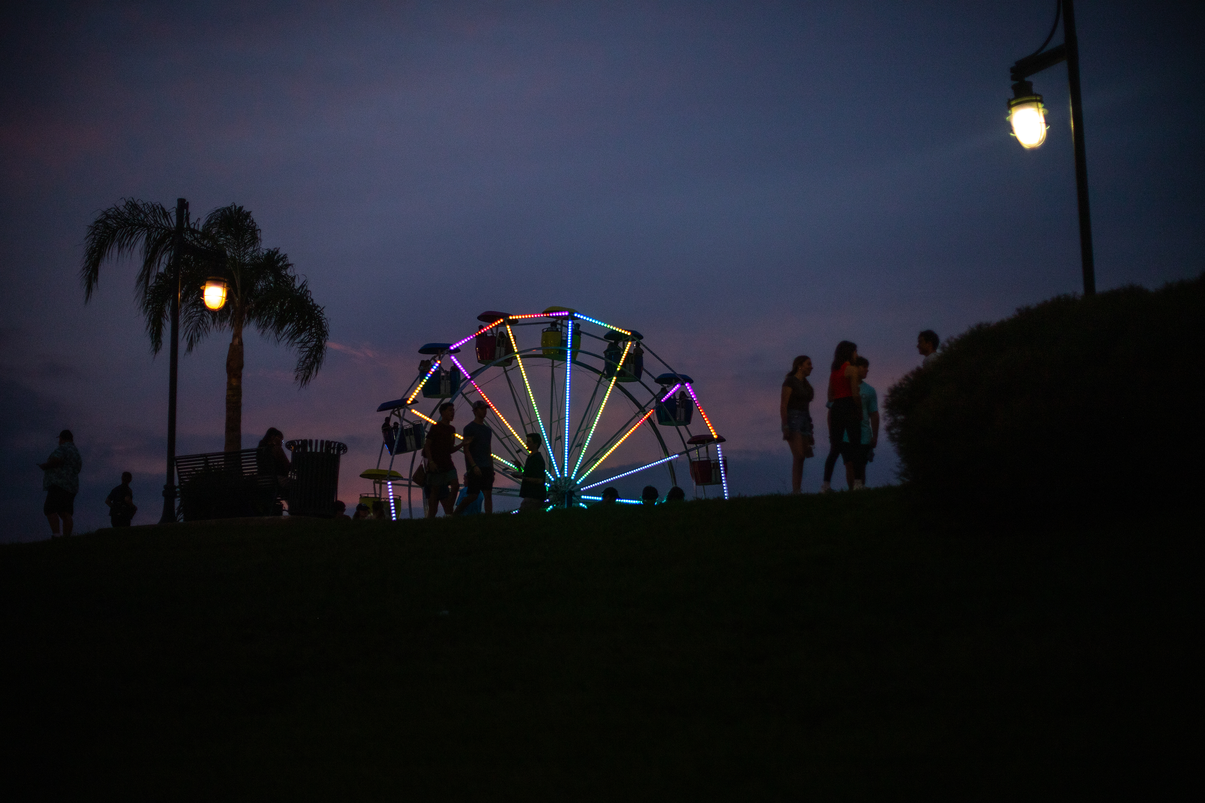 The Ferris wheel lights up the waterfront at the Gretna festival on the 5th October. The festival attracts thousands of people a year and comprises local food vendors, music acts, art, and cultural performances. Families enjoy the festivities right up until the doors close at 10pm.
