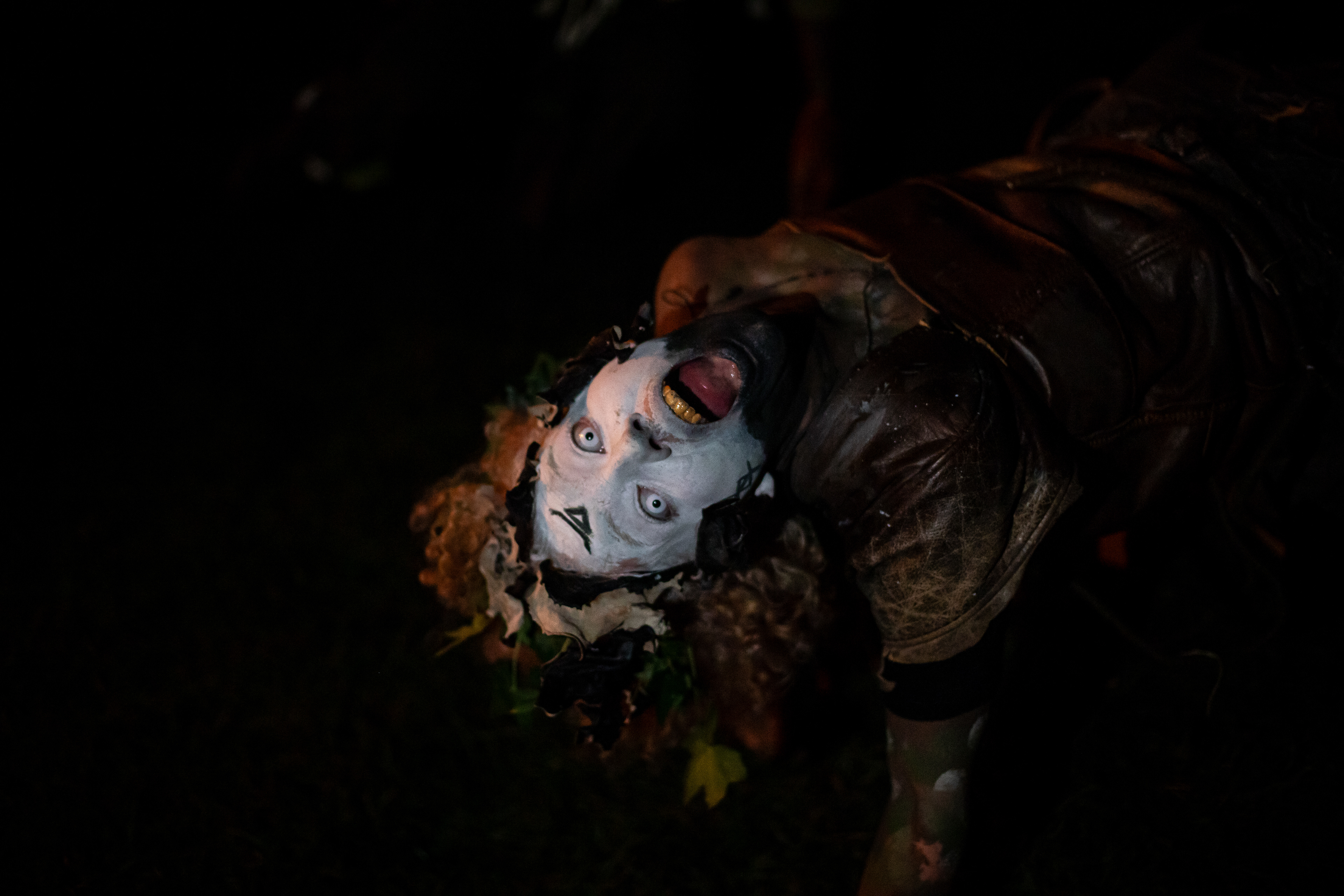A performer in character bends over backwards and poses at the festival. Performers at the event are believers in pagan ritual and spend hours beforehand getting into character of the evening.