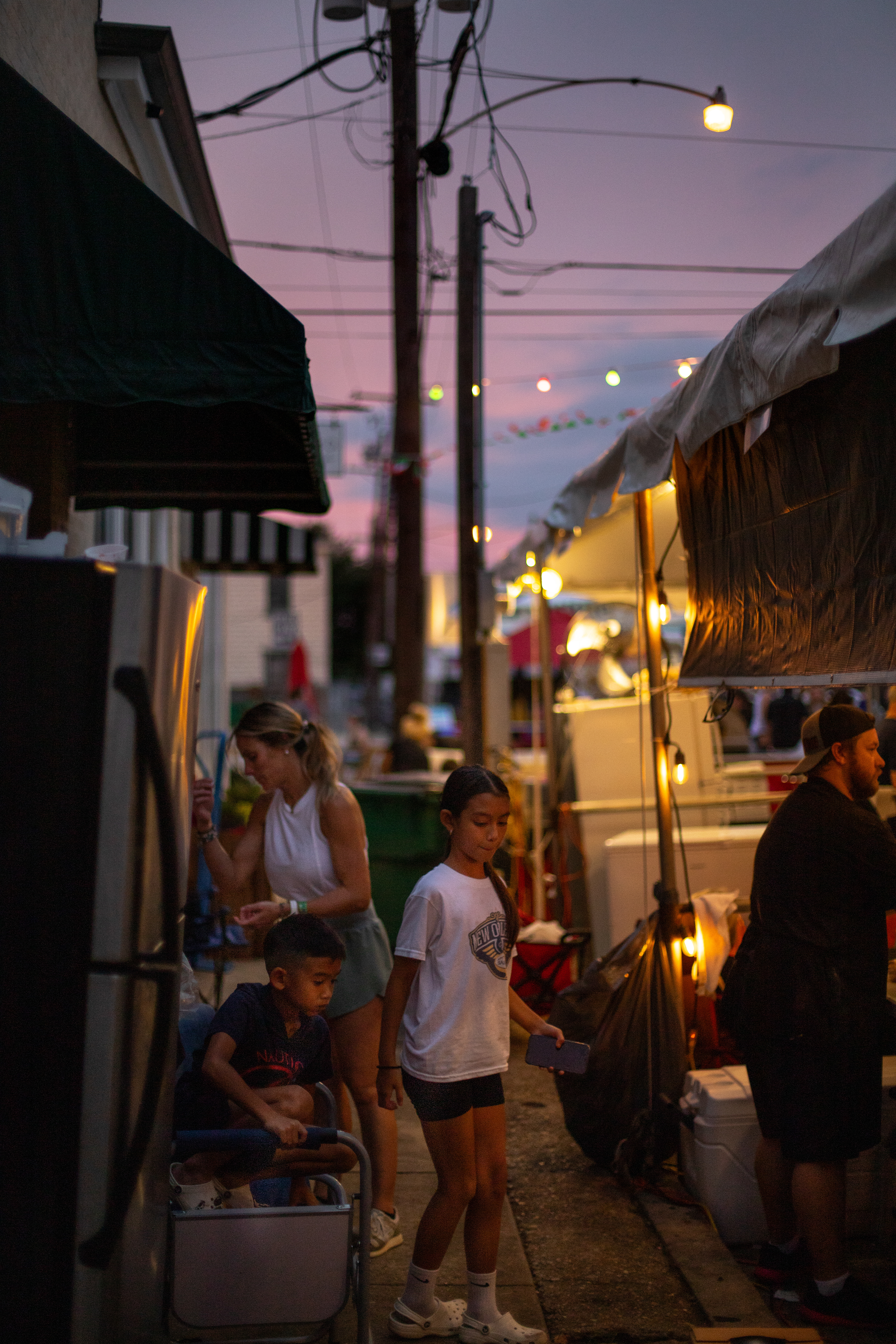 Other vendors take a moment to rest behind their stall after serving a full day at the Gretna festival on Oct. 5th. The festival attracts thousands of people a year and comprises local food vendors, music acts, art, and cultural performances. Their stall in located in the Italian section of the festival grounds and they are called "the Meatballerz".