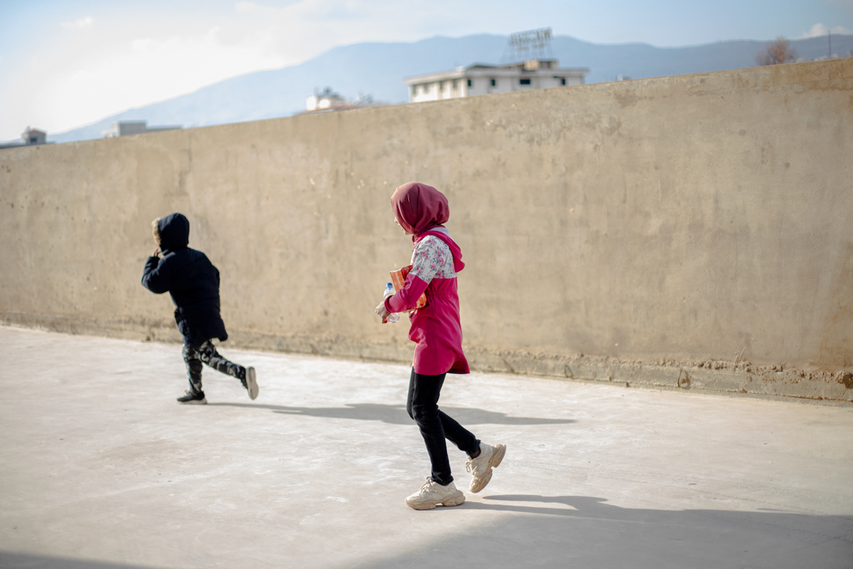 A young girl runs for the school bus at the Triumphant Mercy educational centre to return to her home located in one of the informal camps in the Beka Valley. Since photographing this educational centre, it was closed down by the government and forced to move online. (12/20/2024)