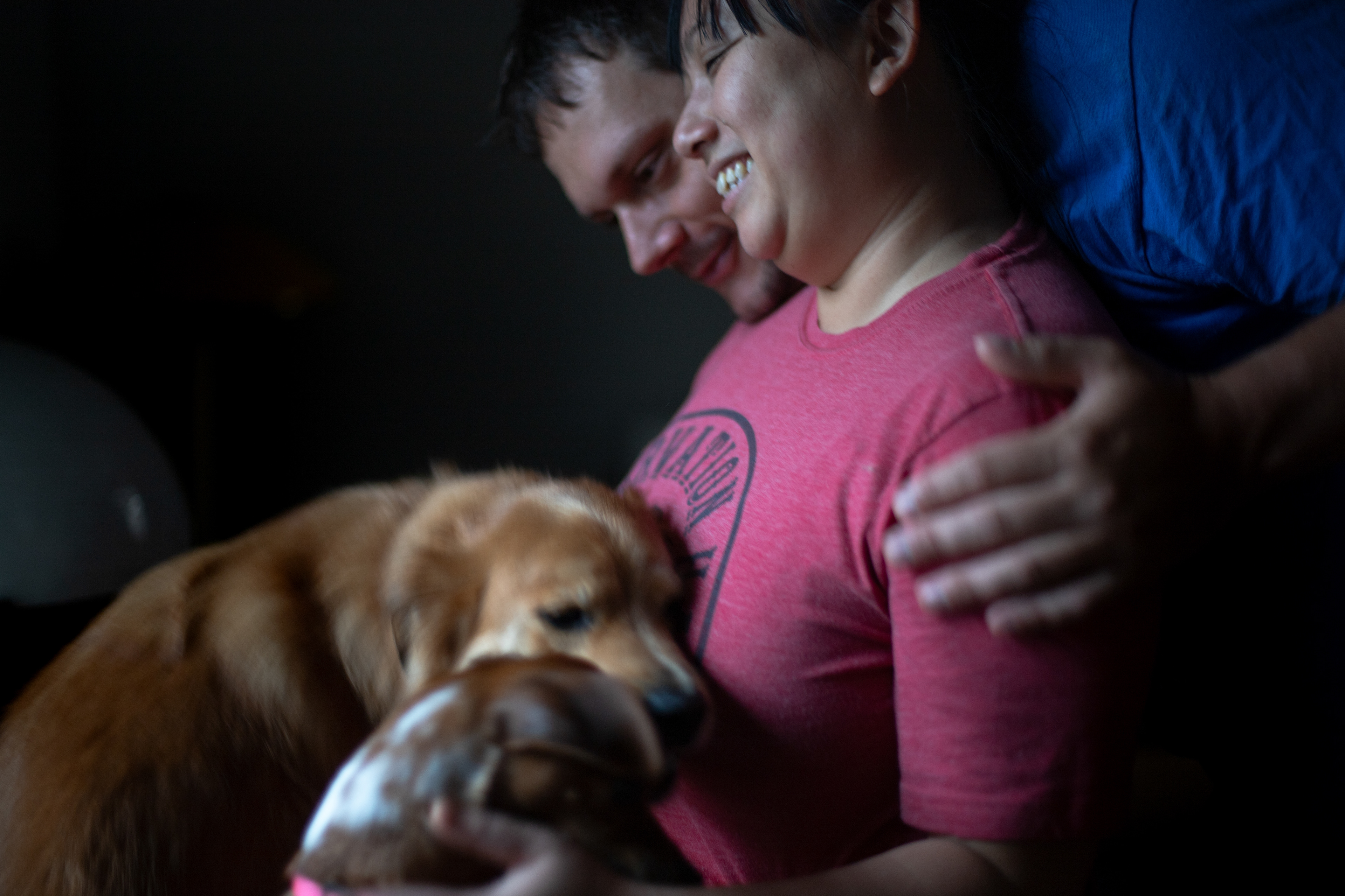 Anh Luu poses for a photo in her home with her partner Sam and her two dogs Mac and April. Sam came with Anh Luu from Oregon to New Orleans when she decided to return from Oregon in 2020.
