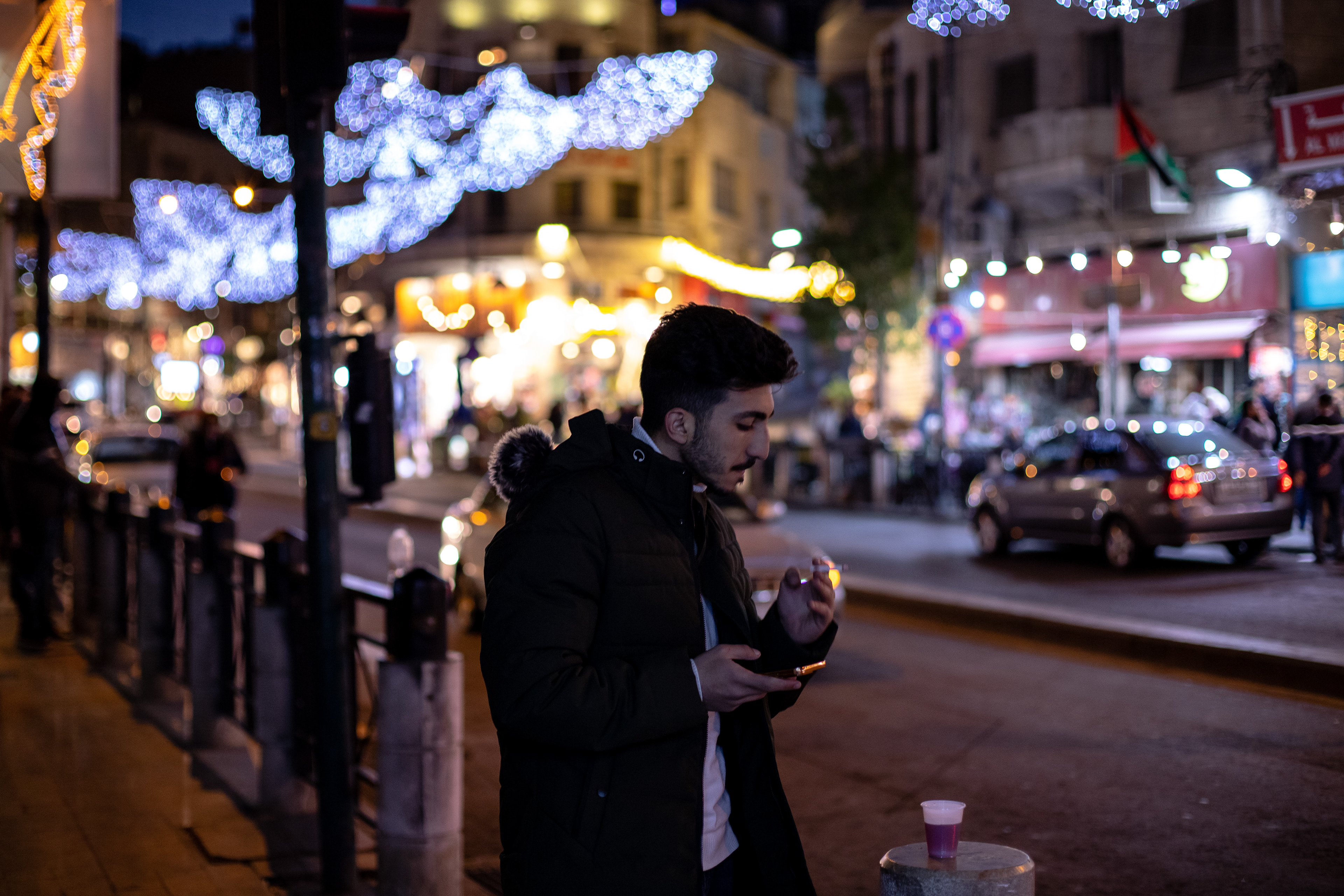 A young man breaks his fast on a night during Ramadan and smokes a cigarette.