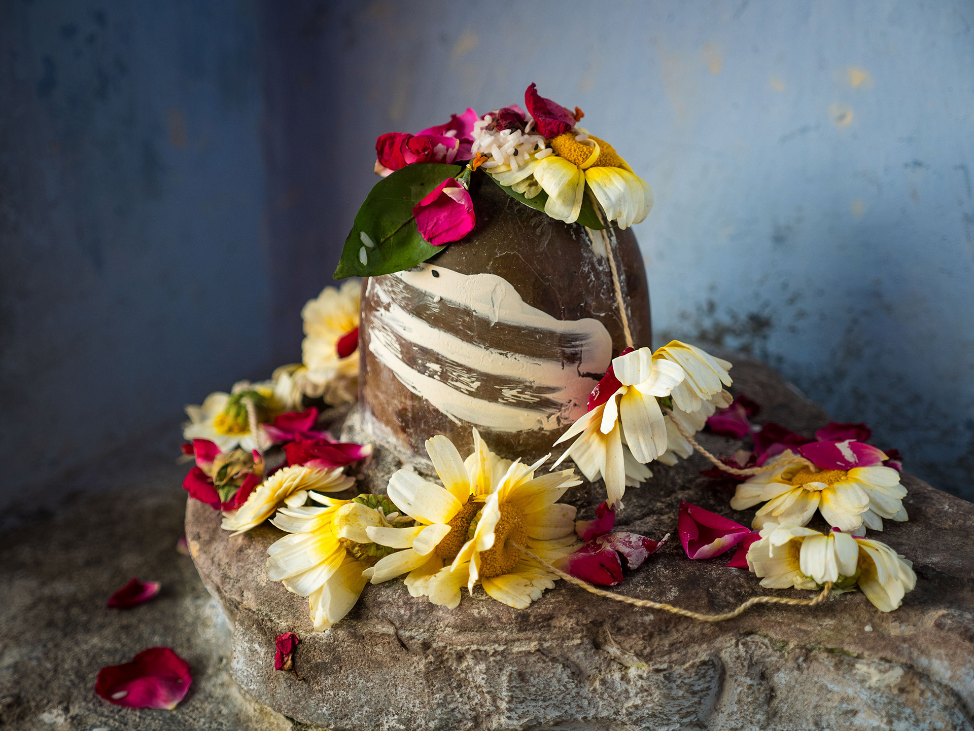 Lingam stone alter decorated with flowers in Varanasi, India {030517_Varanasi_436}