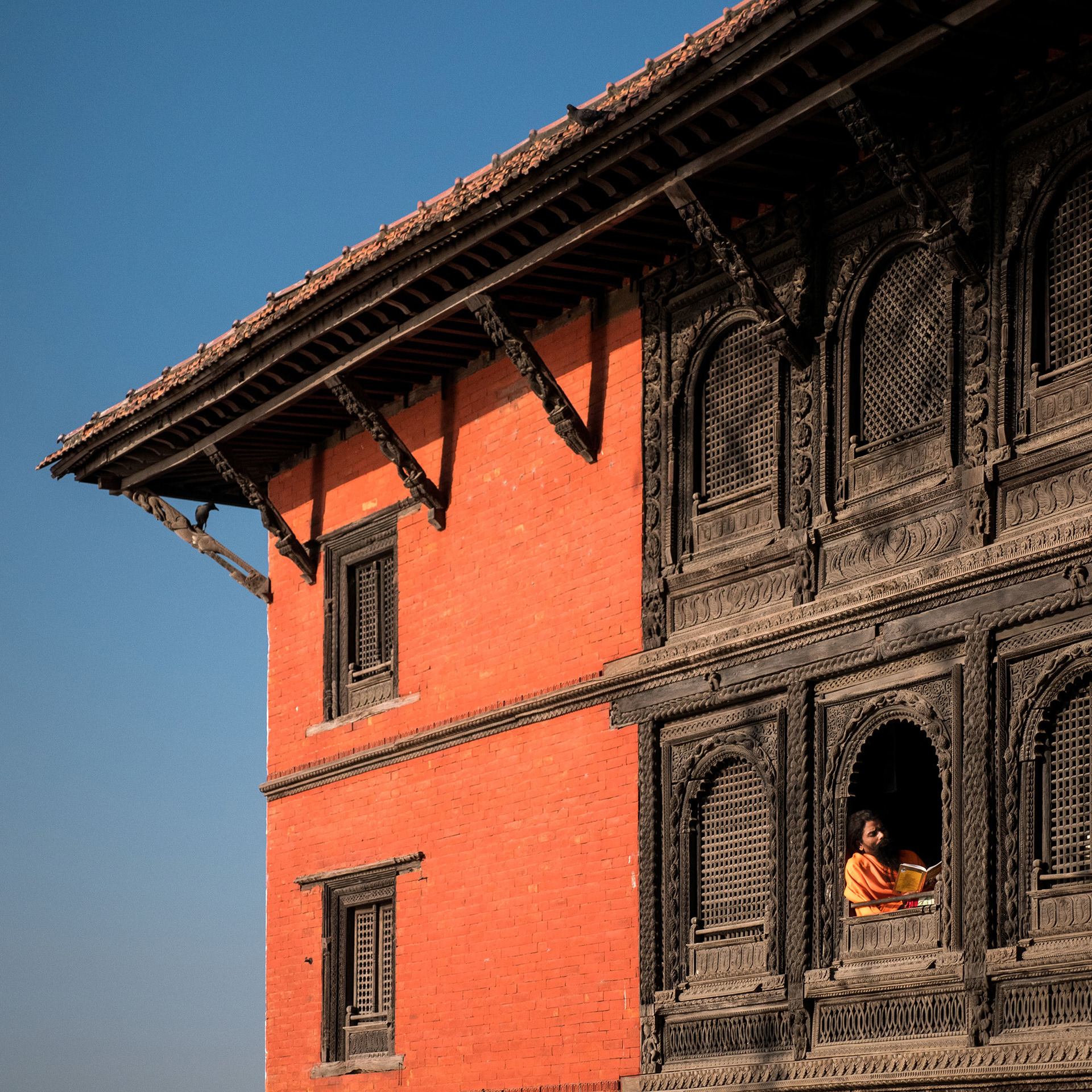 Man reading in window of Shiva Temple in Varanasi, India {030517_Varanasi_469}