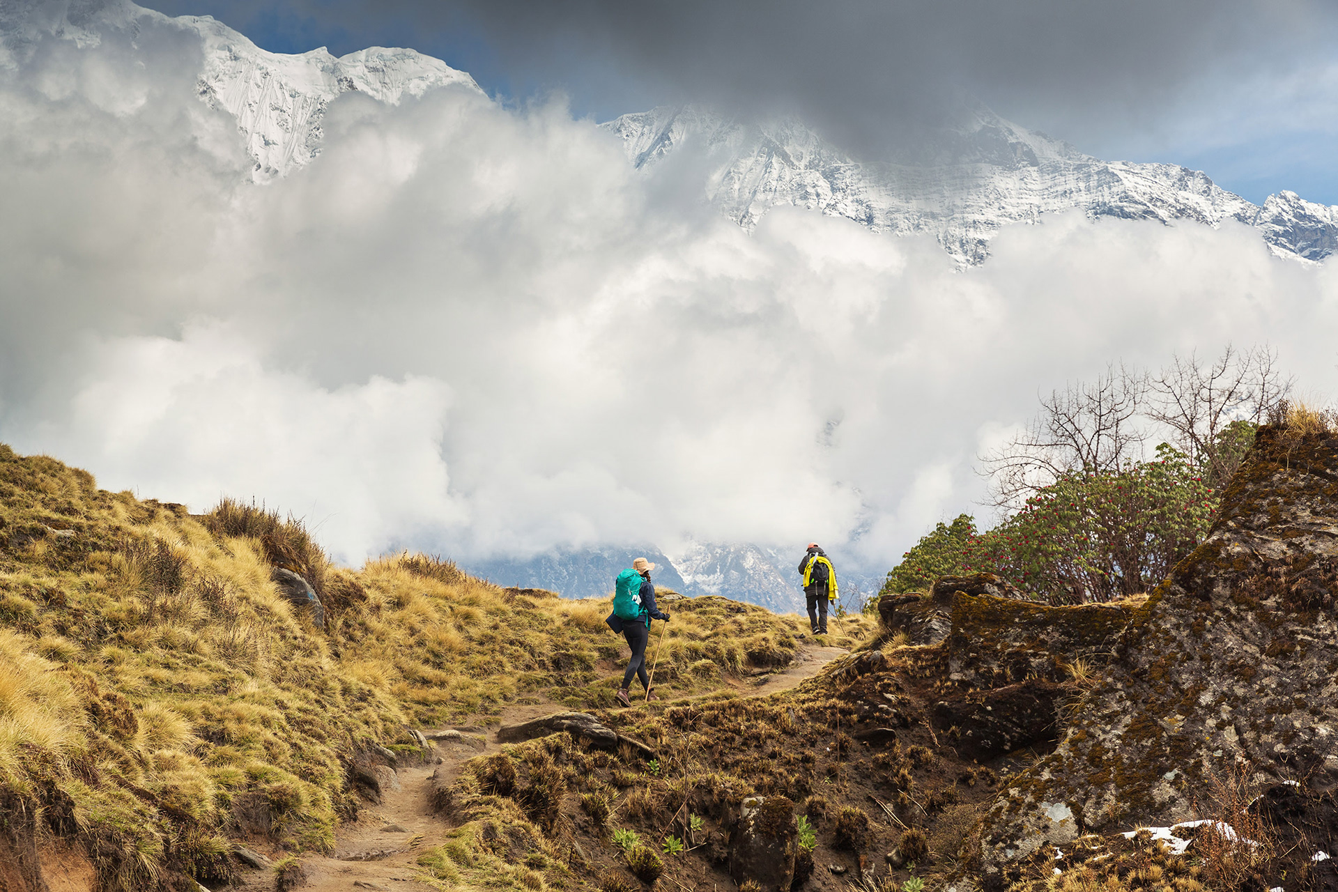 Pair of hikers trekking up to Mardi Himal,  Annapurna mountain range, Nepal {040118_Nepal_1540}
