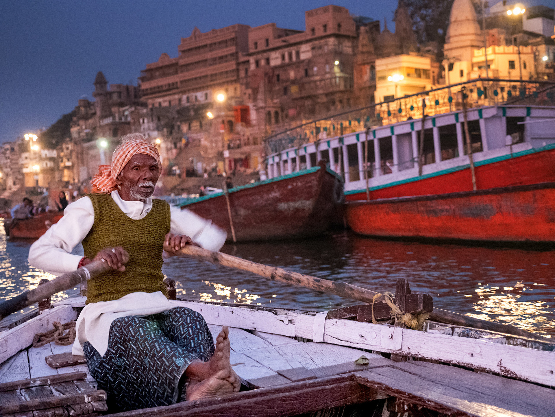 Man rowing a boat on the Ganges river in Varanasi, India {030517_Varanasi_280}