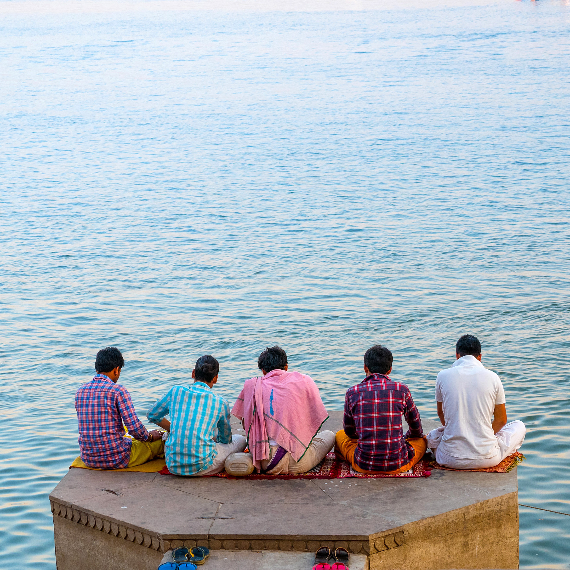Men praying on the edge of the Ganges River, Varanasi, India {030517_Varanasi_200}