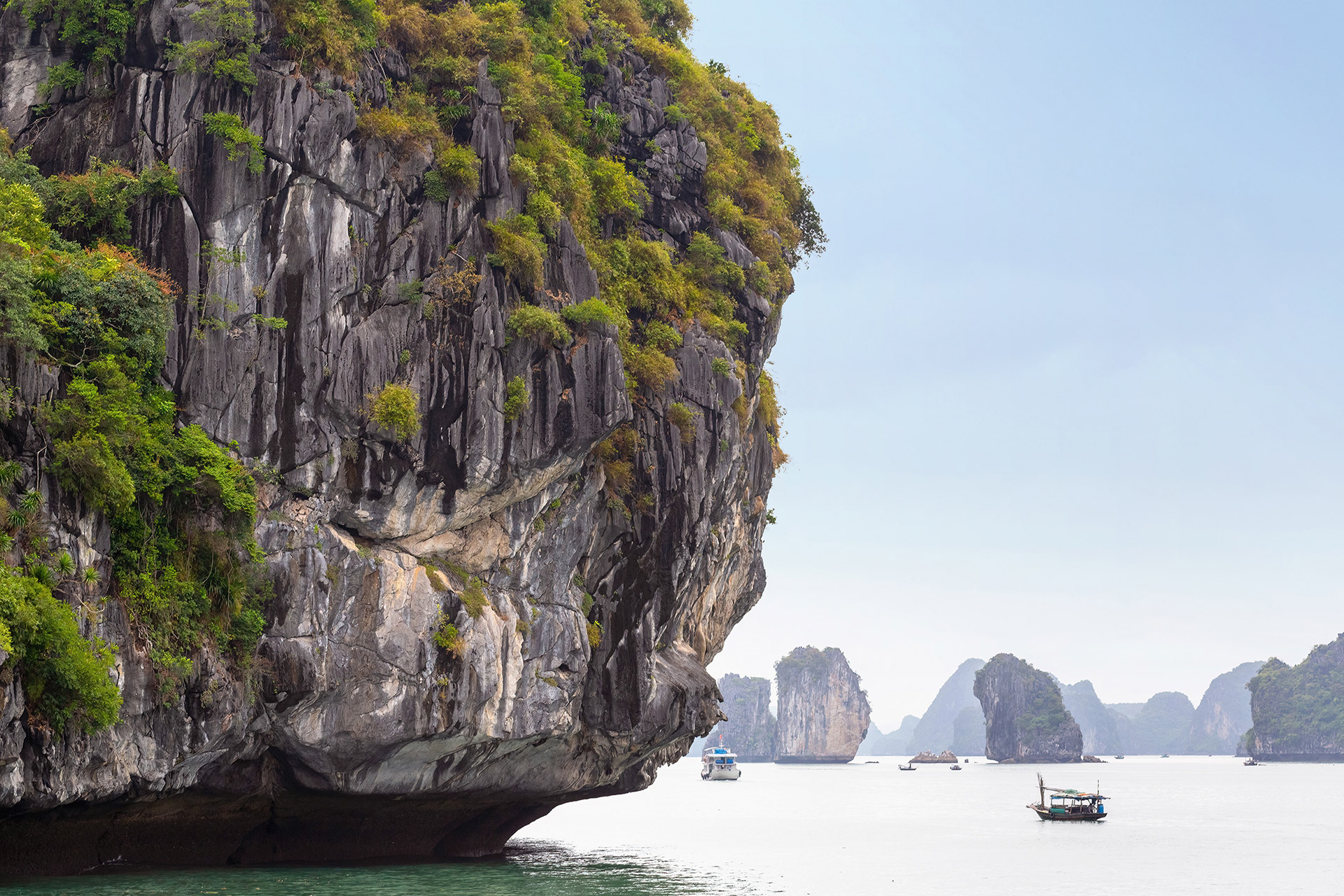 Rock formations and fishing boats at Ha Long Bay, Vietnam {051118_CatBa_055}