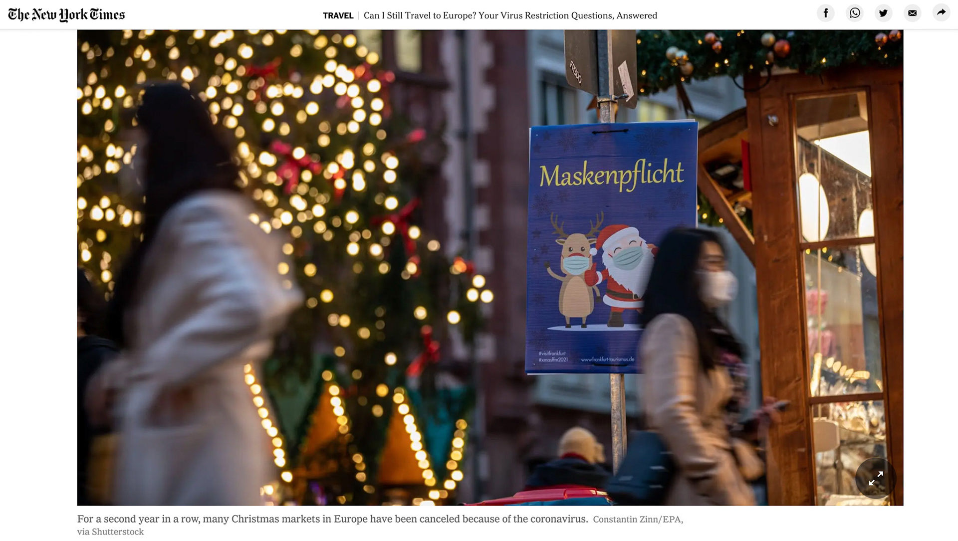 A sign reading 'Mask Required' is placed at the entrance of the Christmas market in Frankfurt, Germany, 23 November 2021. Germany has witnessed a rising number of COVID-19 infections amid the ongoing SARS-CoV-2 coronavirus pandemic. EPA-EFE/CONSTANTIN ZINN